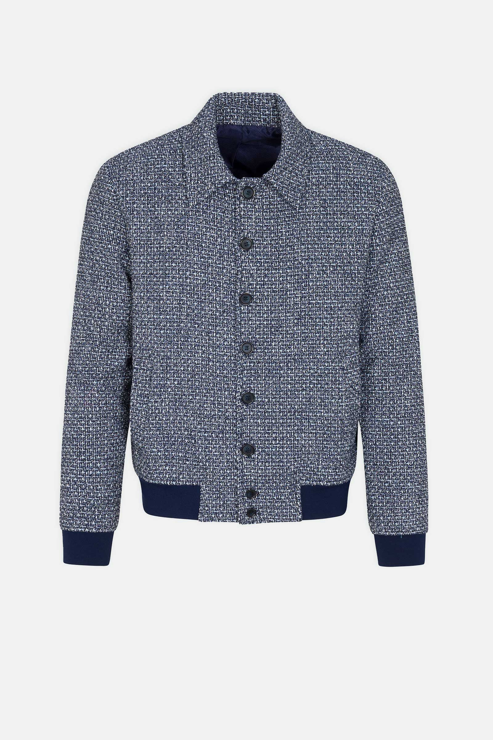 The Lowen Tweed Jacket is a blue and white textured bomber with a collared neckline, black front buttons, and navy ribbed cuffs and waistband, displayed against a white background.