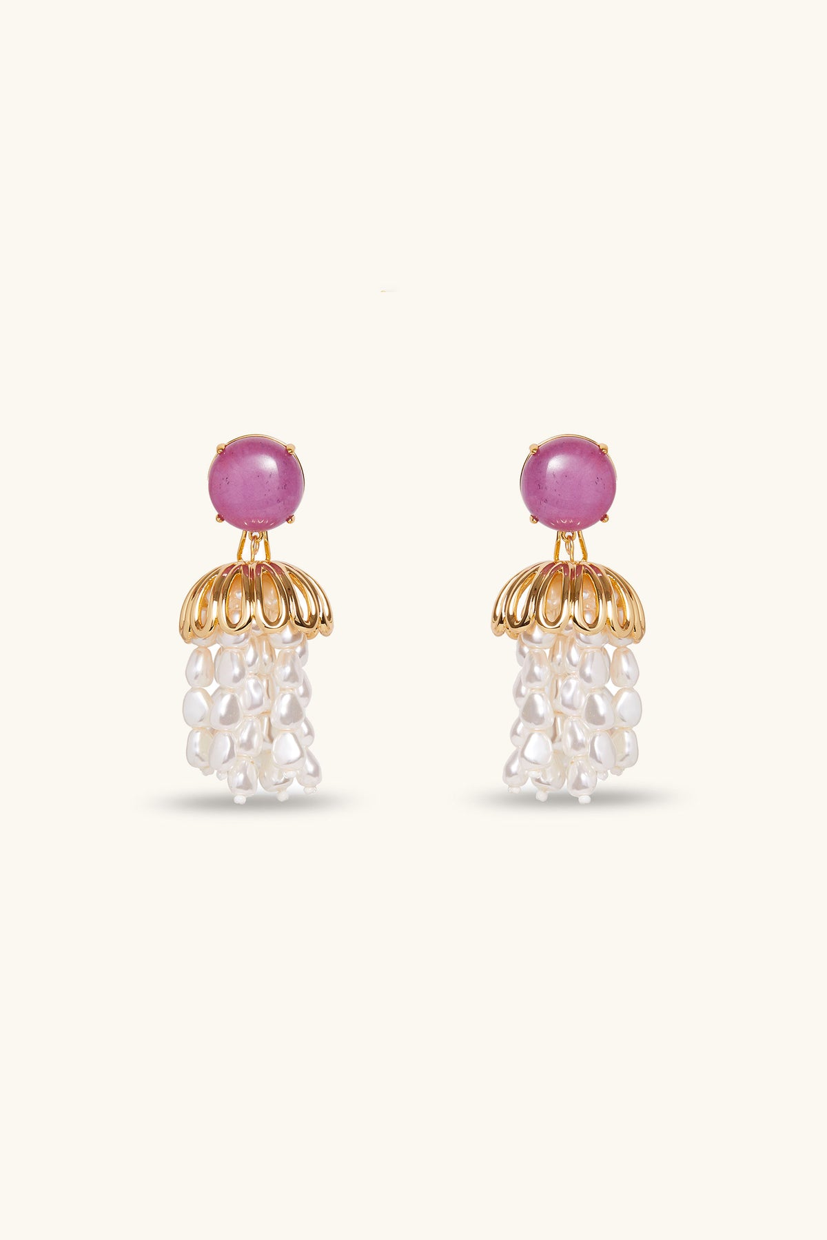 Lele Sadoughi x Trina Turk Parapluie Strand Earrings in lavender feature round stones on top, a gold dome-shaped design below, and clusters of white pearl-like beads hanging beneath, set against a light background.