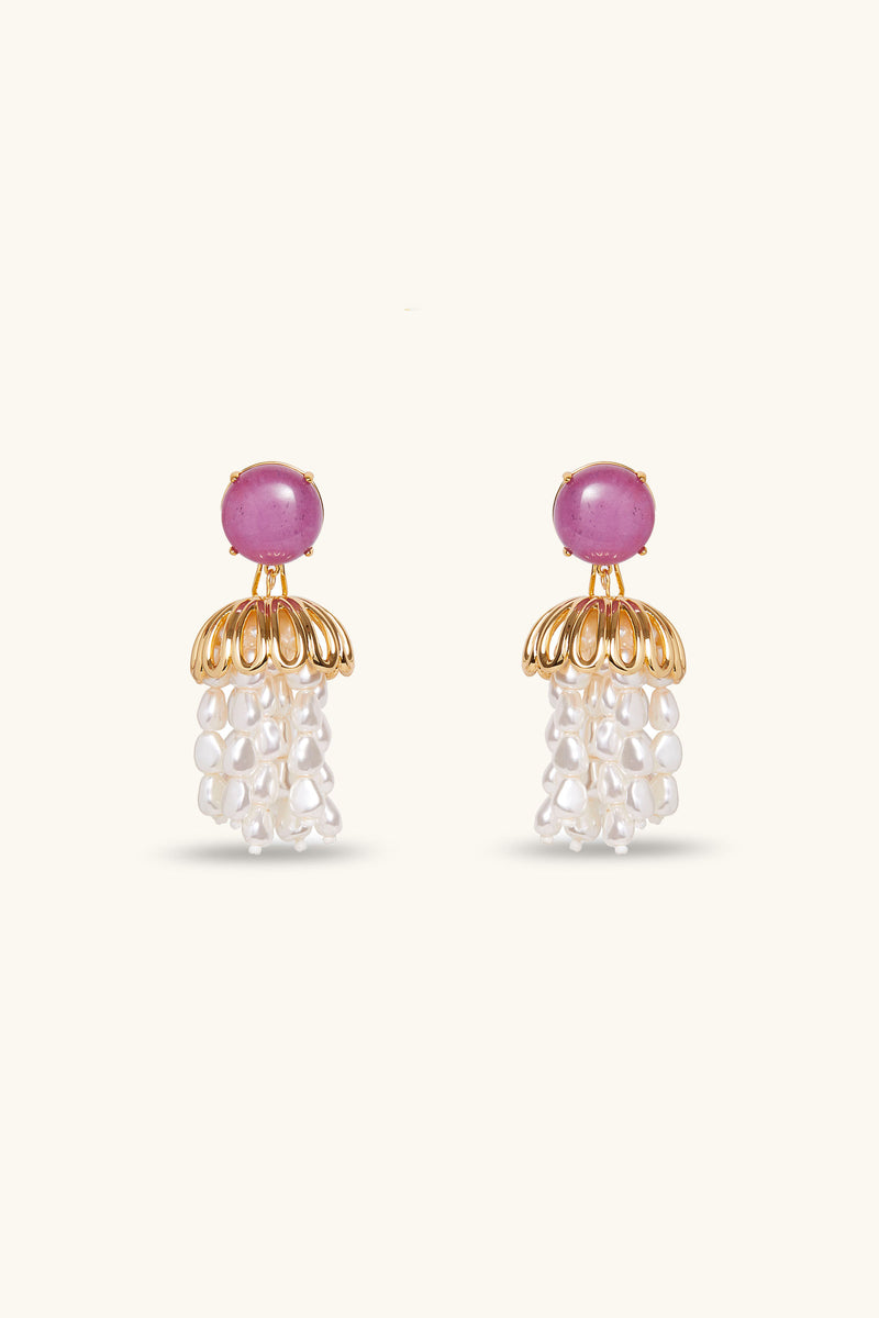 Lele Sadoughi x Trina Turk Parapluie Strand Earrings in lavender feature round stones on top, a gold dome-shaped design below, and clusters of white pearl-like beads hanging beneath, set against a light background.