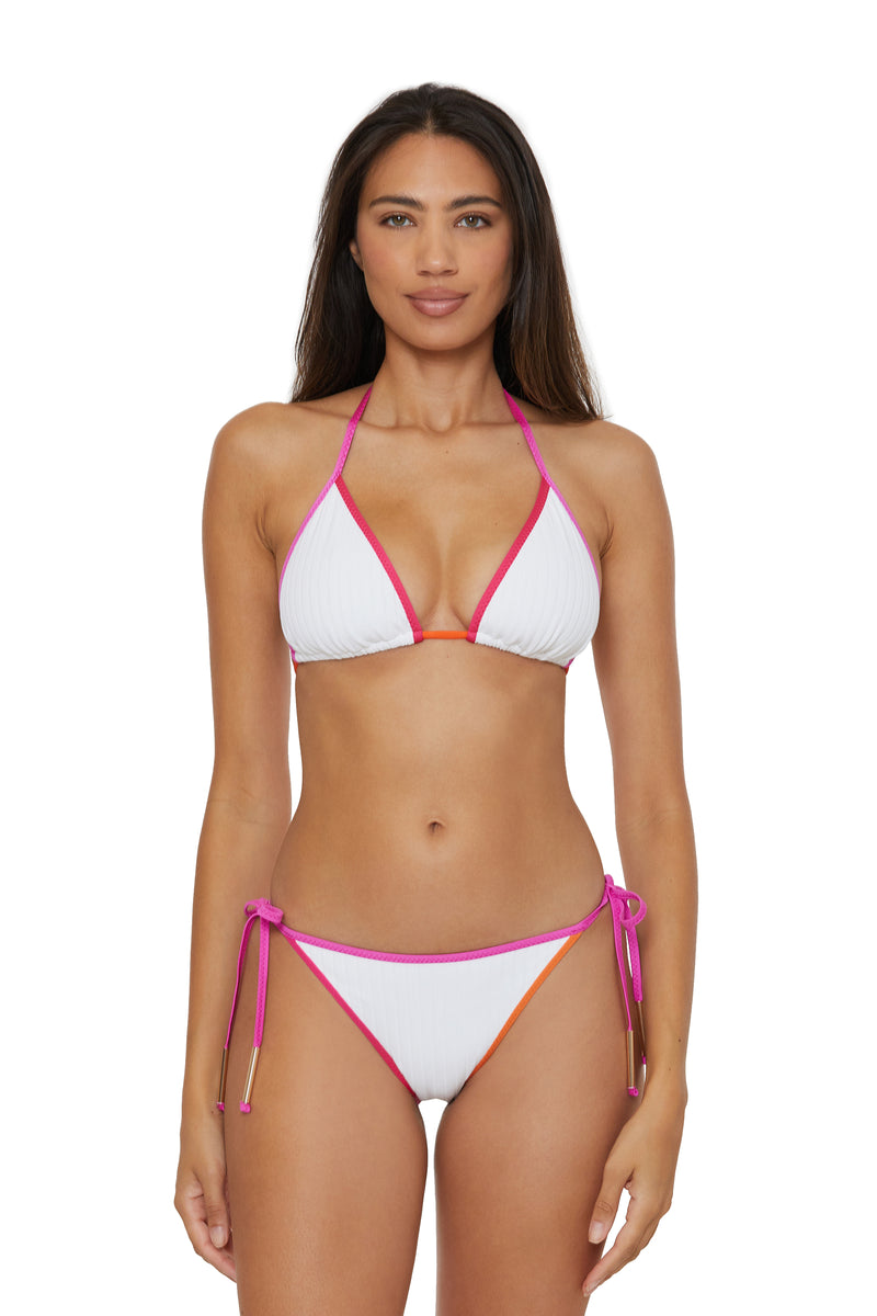 A woman with long brown hair and a neutral expression models the Maori Tie Side Hipster Swim Bottom, featuring pink and orange trim. She faces forward in a halter bikini set against a plain white background.