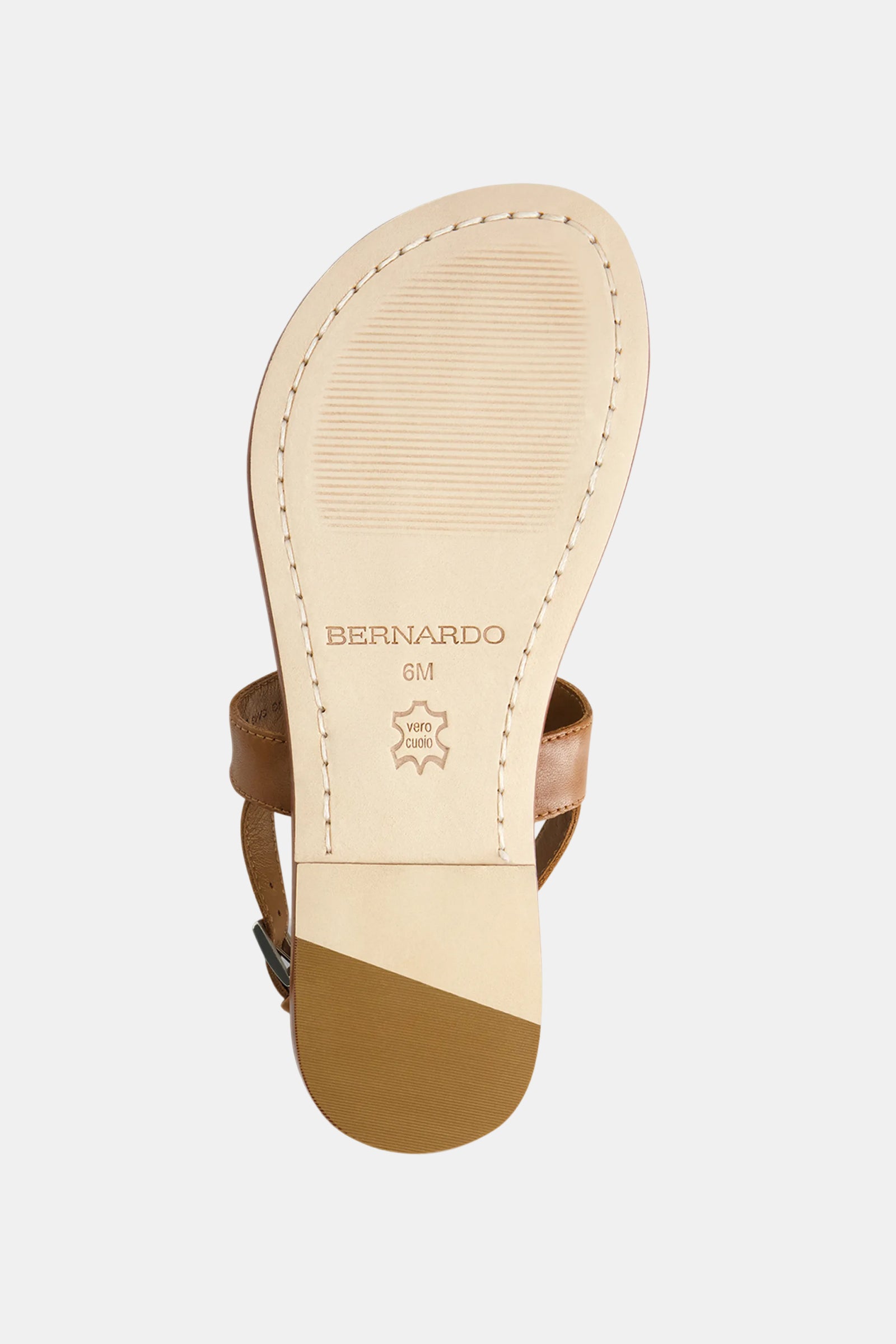 The image shows the sole of a Bernardo Maverick 2 Sandal in tan, featuring "BERNARDO," a 6M size mark, leather symbol, textured grip near the toe, and a reinforced tan rubber heel section.
