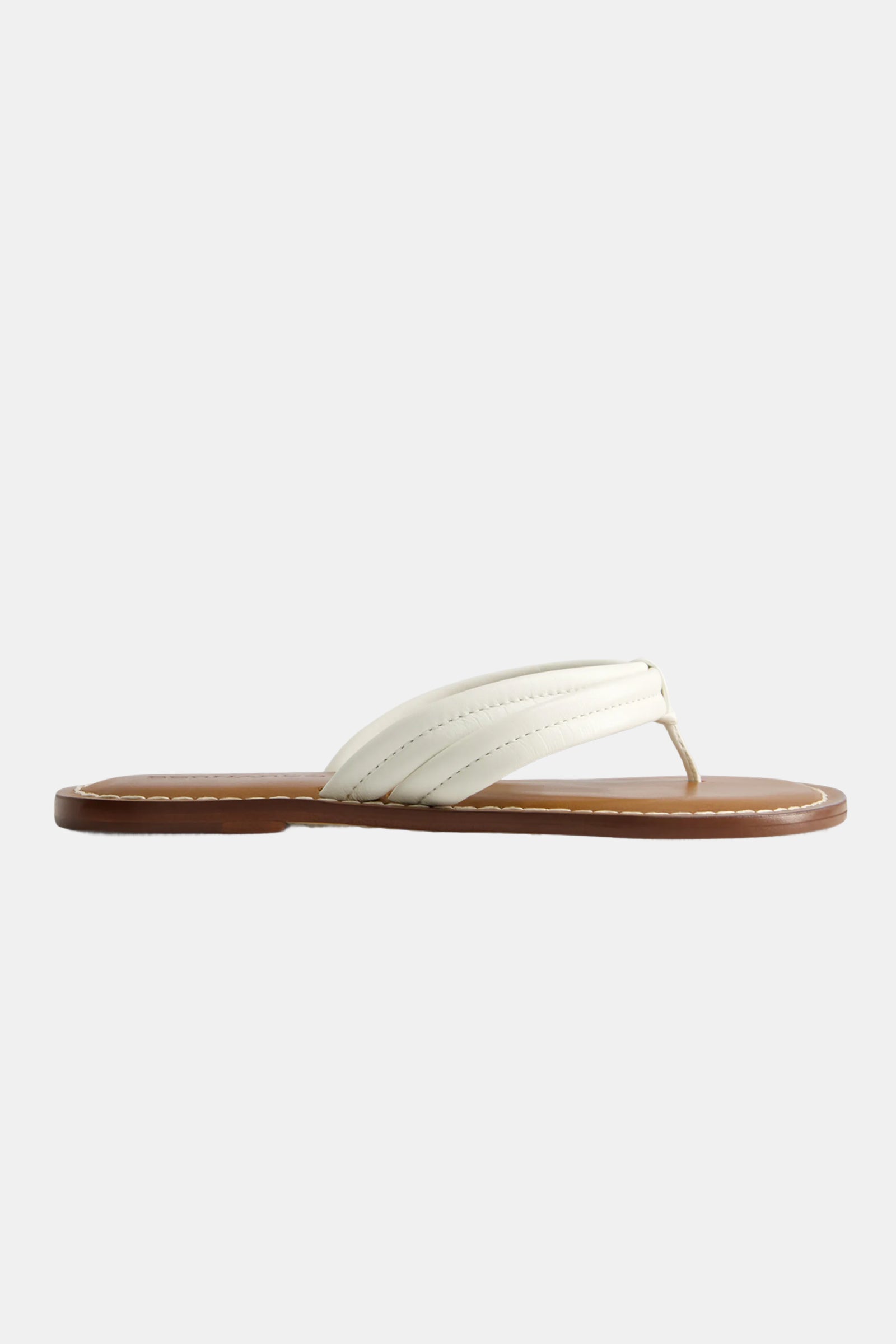 The Miami Sandal is a white, flat thong sandal featuring a brown sole with visible stitching, displayed in side profile against a plain light background.
