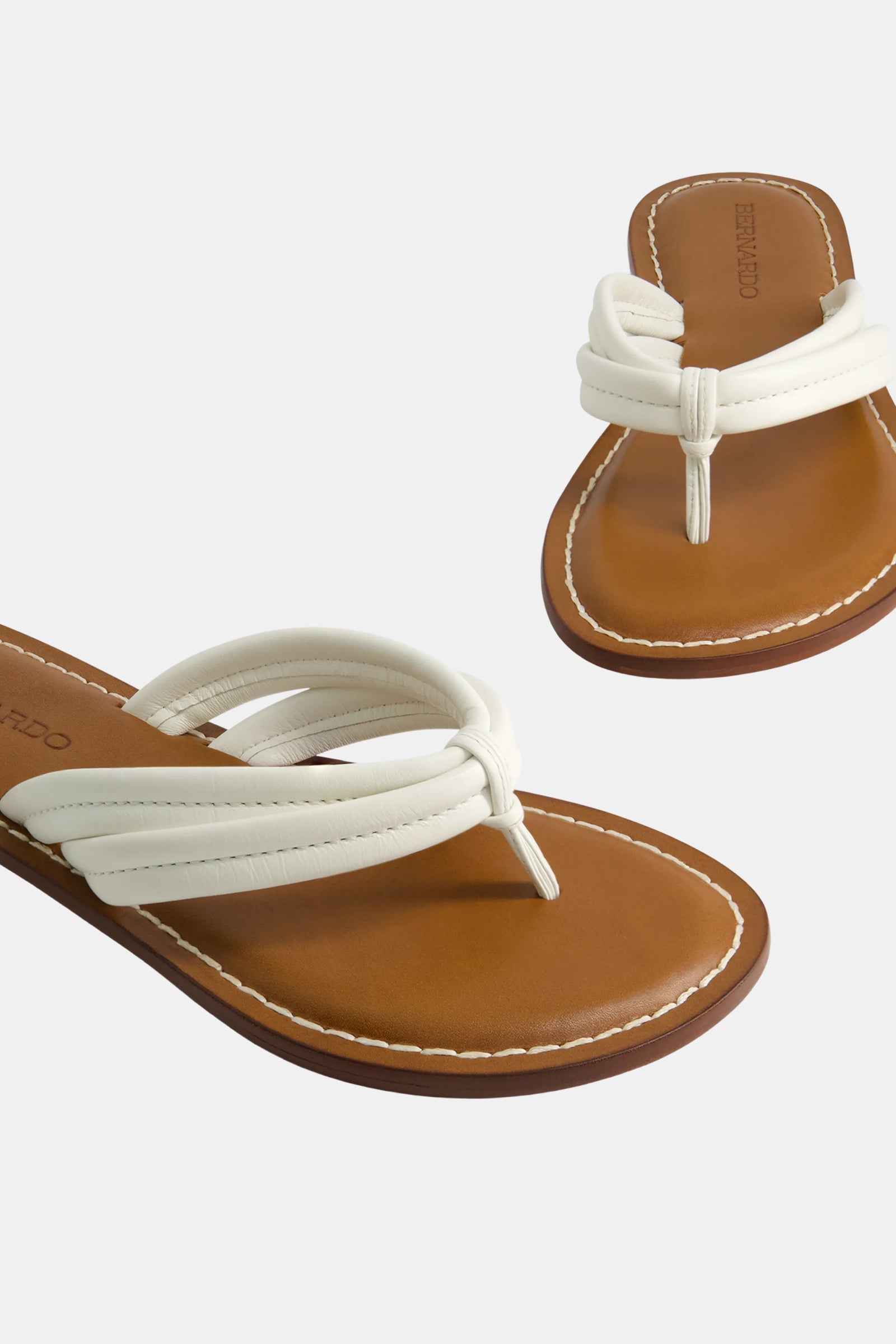 The Miami Sandal features white and tan flat design with brown soles, white padded loop straps, visible white stitching, and is displayed on a plain light background.