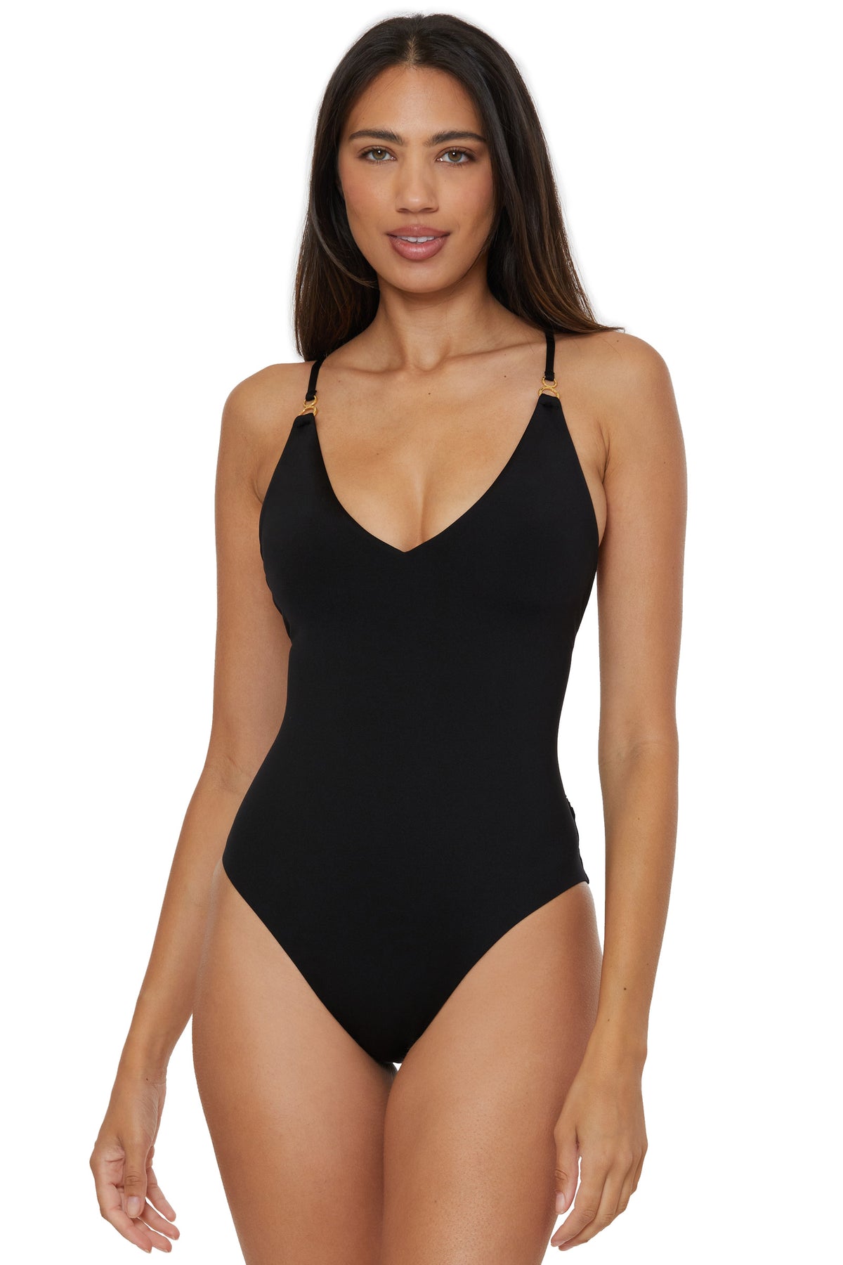 A woman with long dark hair is wearing the Monaco Twist Back One-Piece Swimsuit in black, featuring thin straps and a V-neckline, standing against a white background.