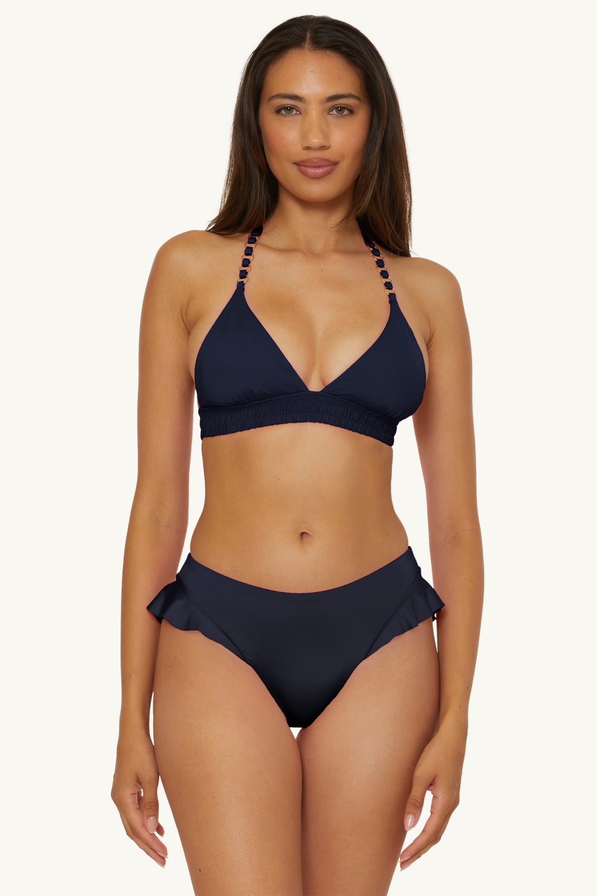 A woman faces forward against a plain light background, wearing the Ring Halter Swim Top in Monaco, paired with matching bikini bottoms.
