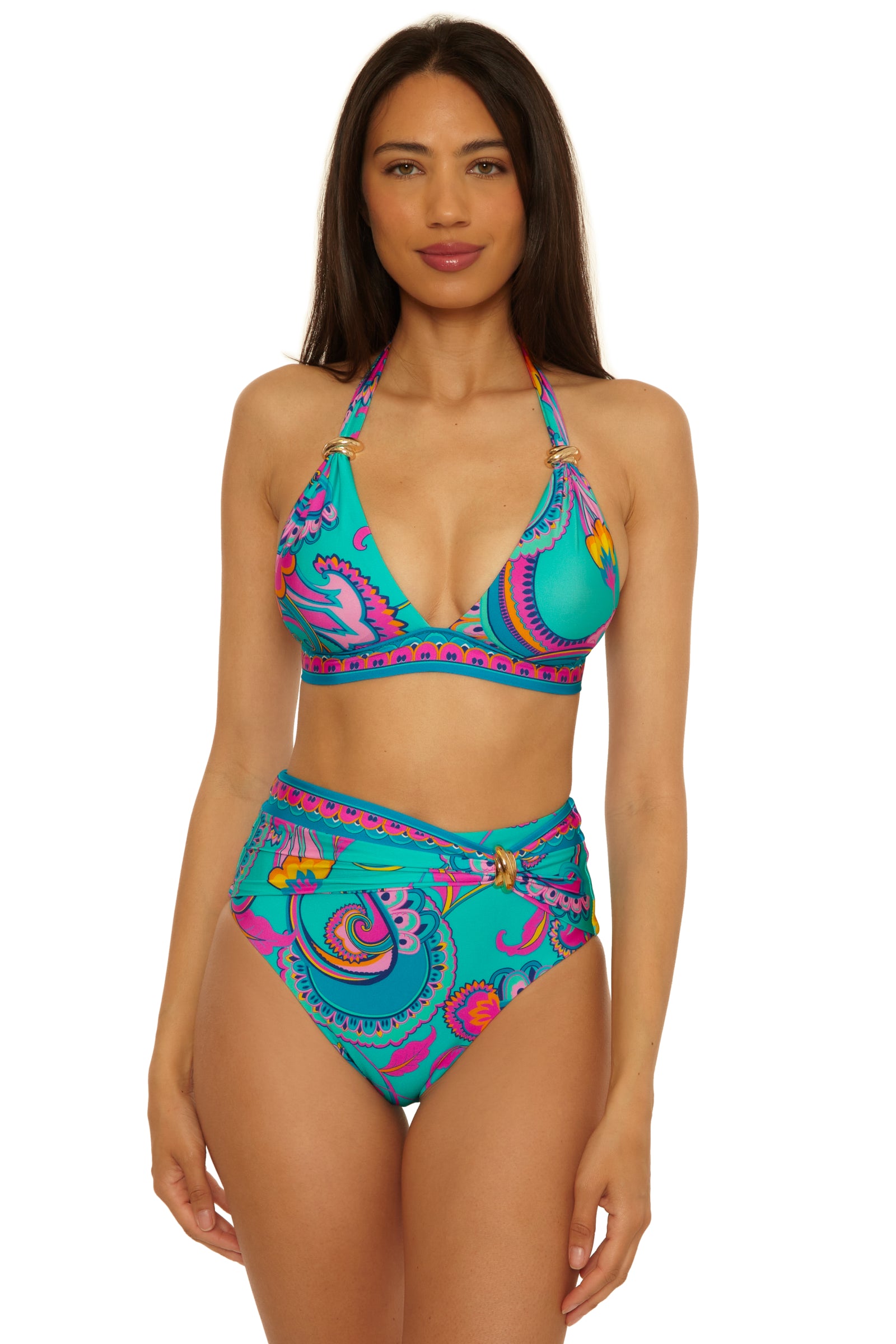 A woman models the Mykonos Belted Hi Waist Bottom, a turquoise bikini with a colorful paisley pattern and a halter-style triangle cup top, standing against a plain white background.