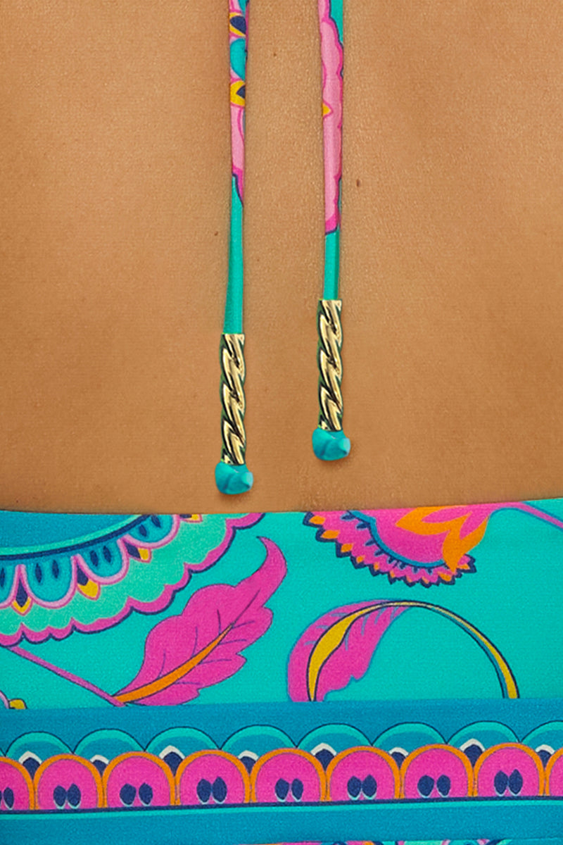 Close-up of the back of a person wearing the Mykonos Bandeau Tankini, featuring brightly colored pink, yellow, and purple patterns with teal neck ties finished with gold tips.