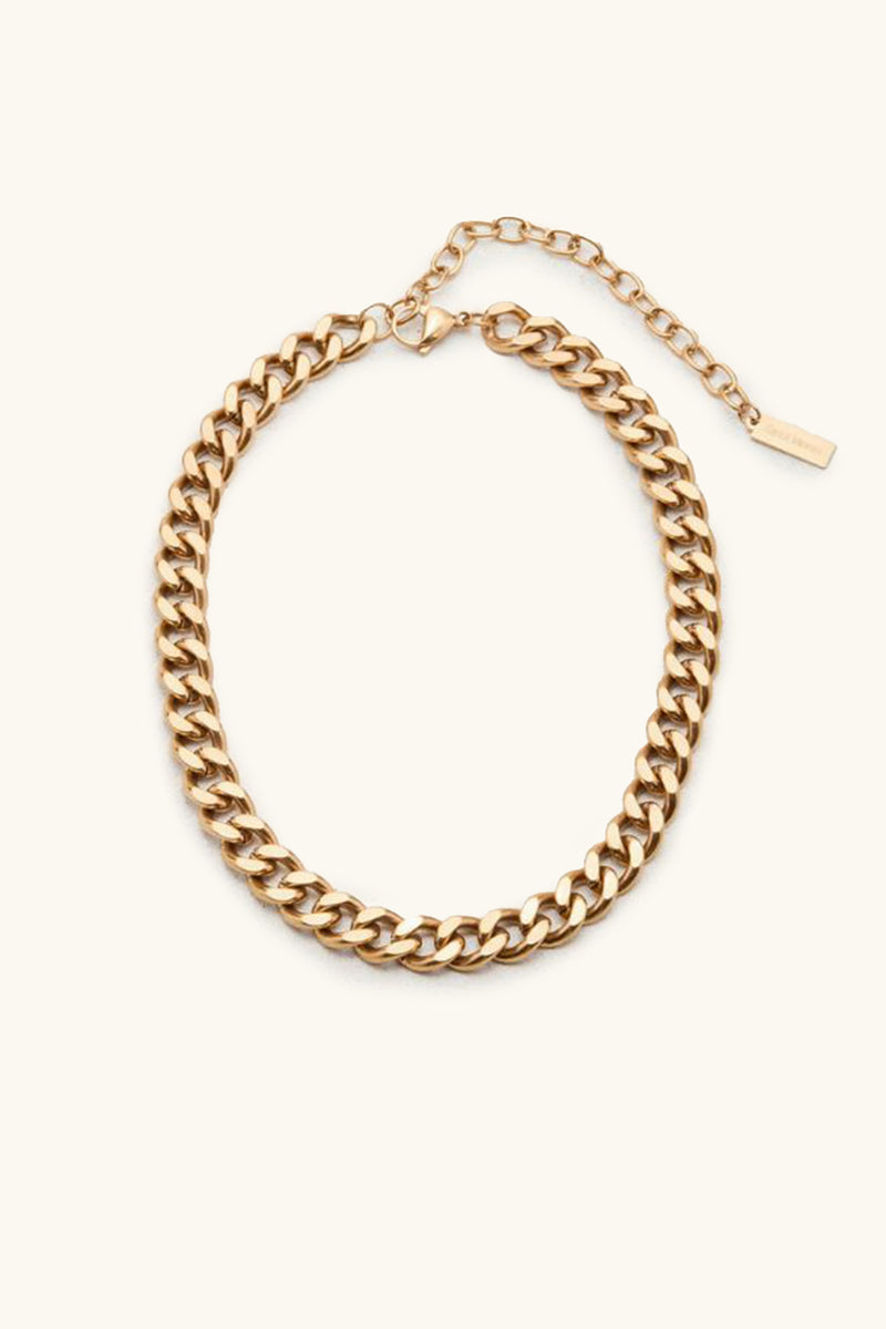 The Alize Necklace is a gold chain featuring thick, interlocking links and an adjustable clasp, showcased on a simple light background.