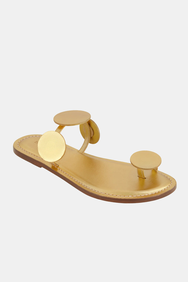 The Bernardo New Moon Sandal is a gold flat sandal with a brown sole, three large circular gold straps, and an open-toe design, shown against a plain white background.