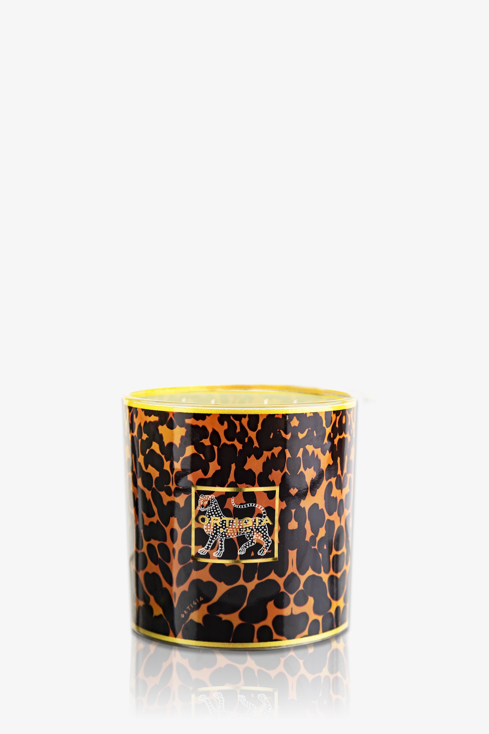 The Ortigia Ambra Nera Large Candle is a decorative yellow candle holder accented with gold trim, featuring a jeweled leopard motif on the front and a stylish animal print design.
