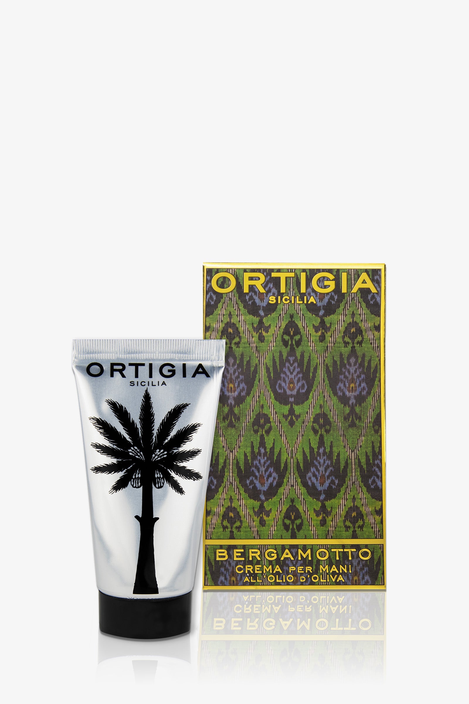 Ortigia Bergamot Hand Cream, in a tube with a black palm tree design, shown next to its decorative green and gold patterned box.