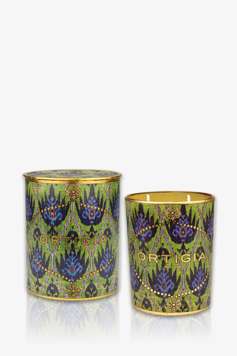 The Ortigia Bergamot Medium Candle features a decorative green geometric pattern and "Ortigia" branding. One candle is lidded, the other open—both add stylish elegance to your space.