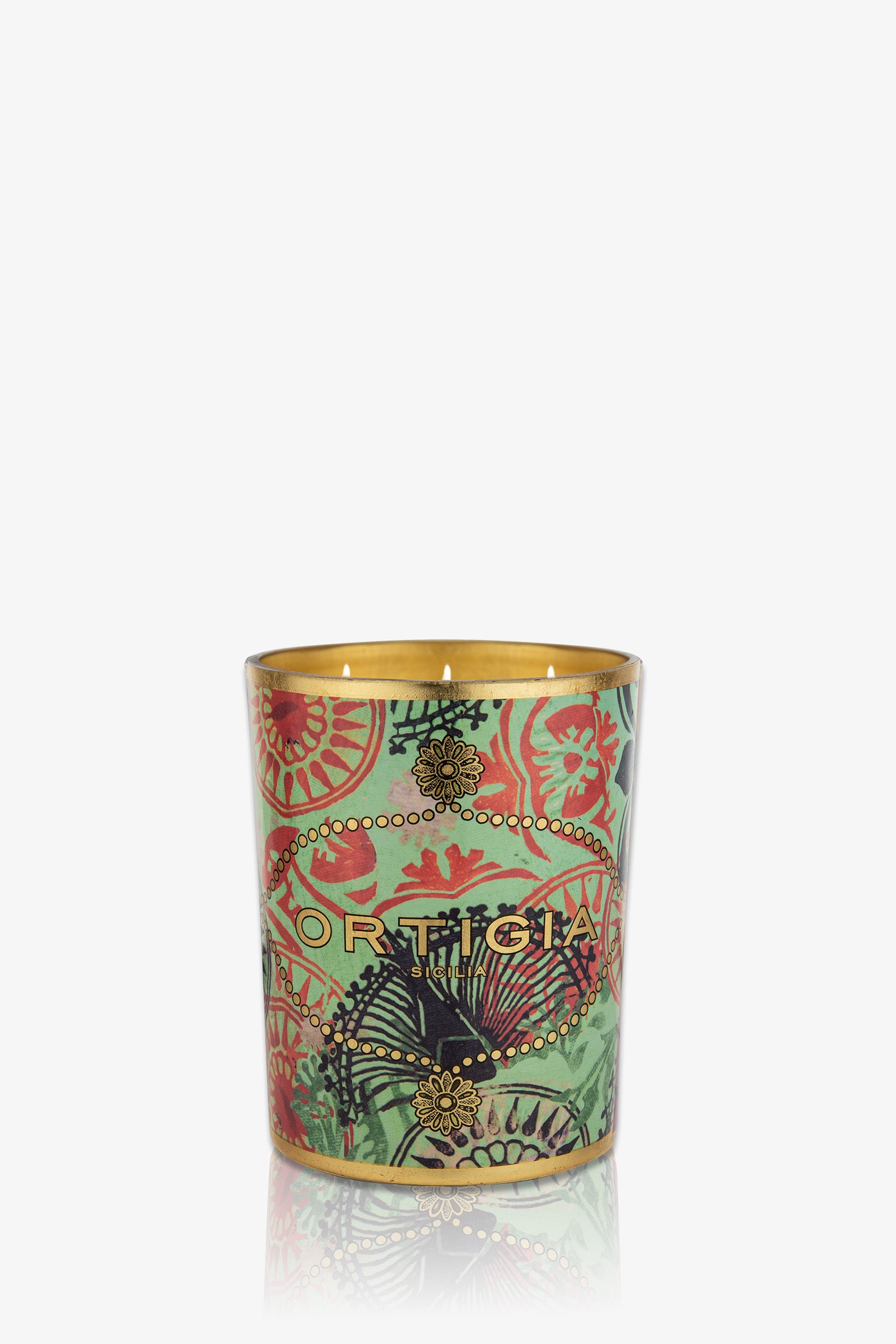 The Ortigia Fico D'India Large Candle features a decorative green glass holder with gold and red floral patterns, the ORTIGIA logo on the front, and a gold interior.