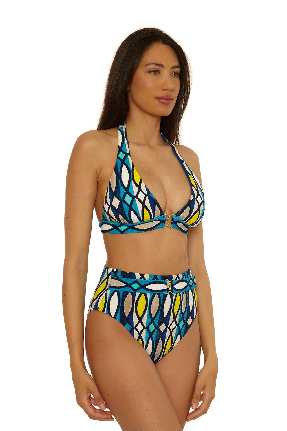A woman wears the Paros Belted Hi Waist Bottom with a matching halter bikini top in a blue, yellow, white, and black geometric pattern, standing against a plain white background.