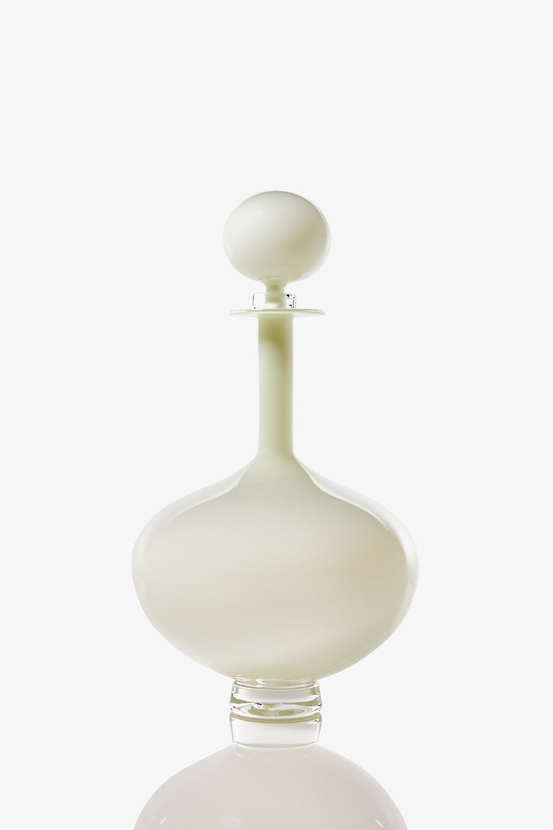 The Petite Genie Bottle Decanter, with a frosted glass body, round stopper, smooth curves, and long neck, is displayed against a white background.
