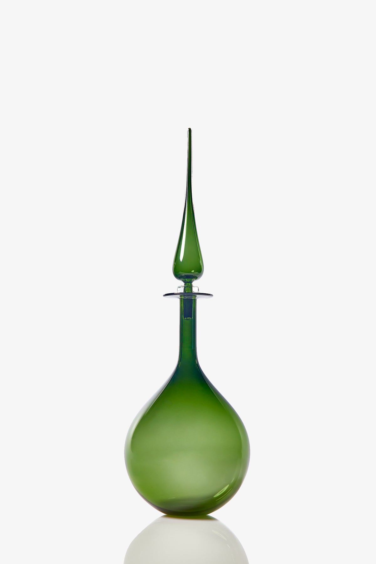 The Petite Tear Drop Decanter features a sleek, green glass design with a round base and long, pointed stopper. Its glossy, translucent finish stands out against a plain white background.