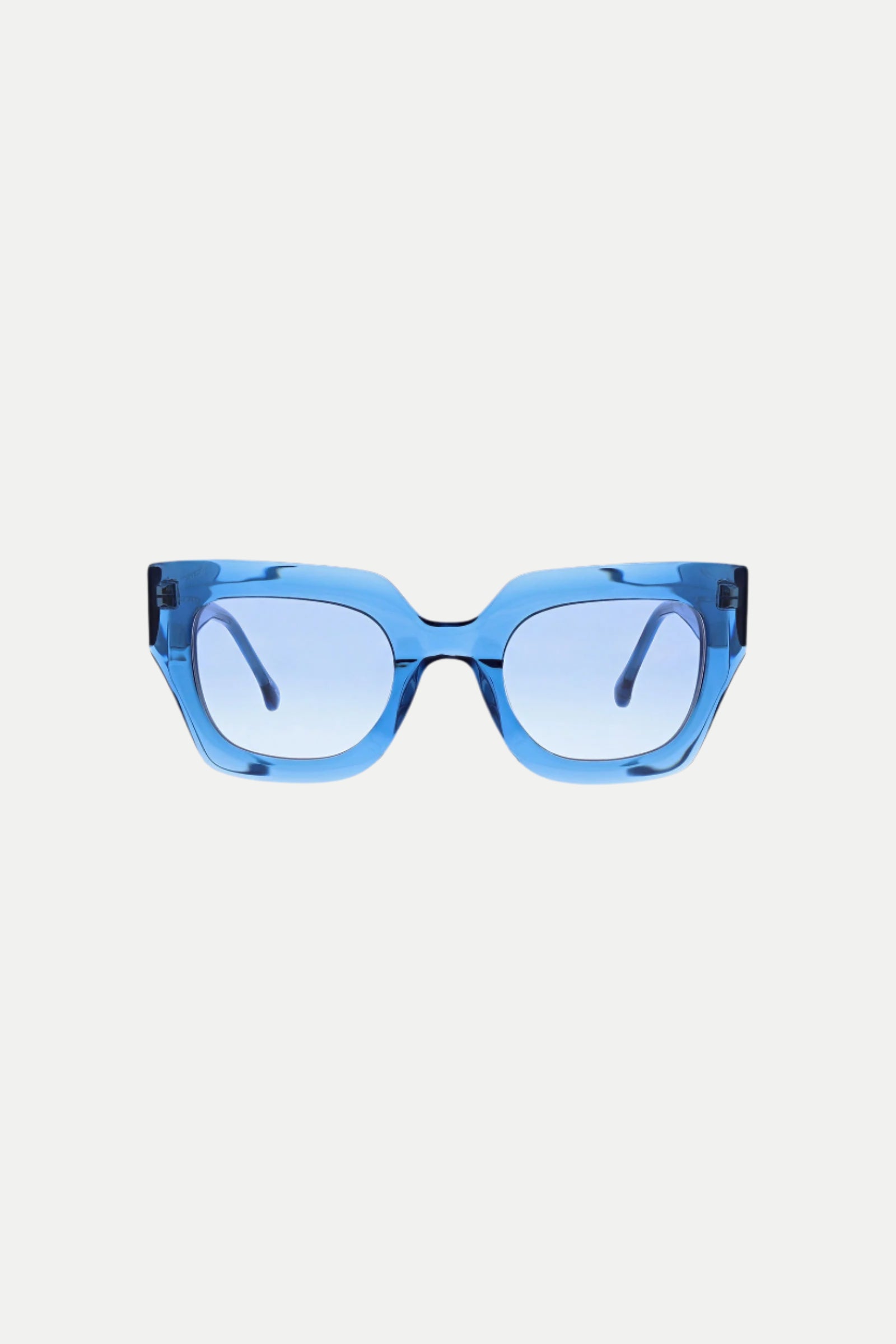 The Sol Wide Frame Square Acetate Sunglasses in blue feature thick, rectangular frames with matching blue-tinted lenses, displayed against a plain white background.