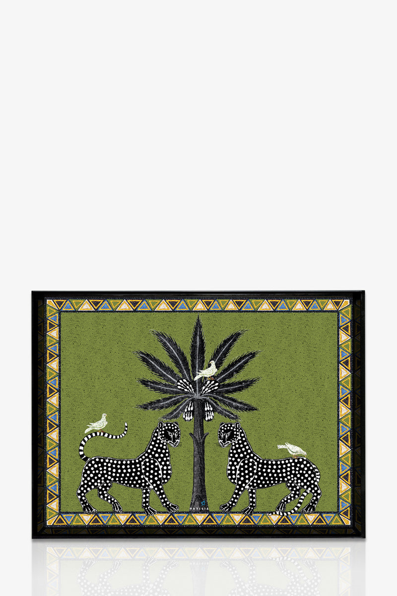 The Ortigia Large Tray is rectangular with a green background, showing two black-and-white spotted leopards facing a tall palm tree with birds on its leaves, all surrounded by a decorative geometric border.