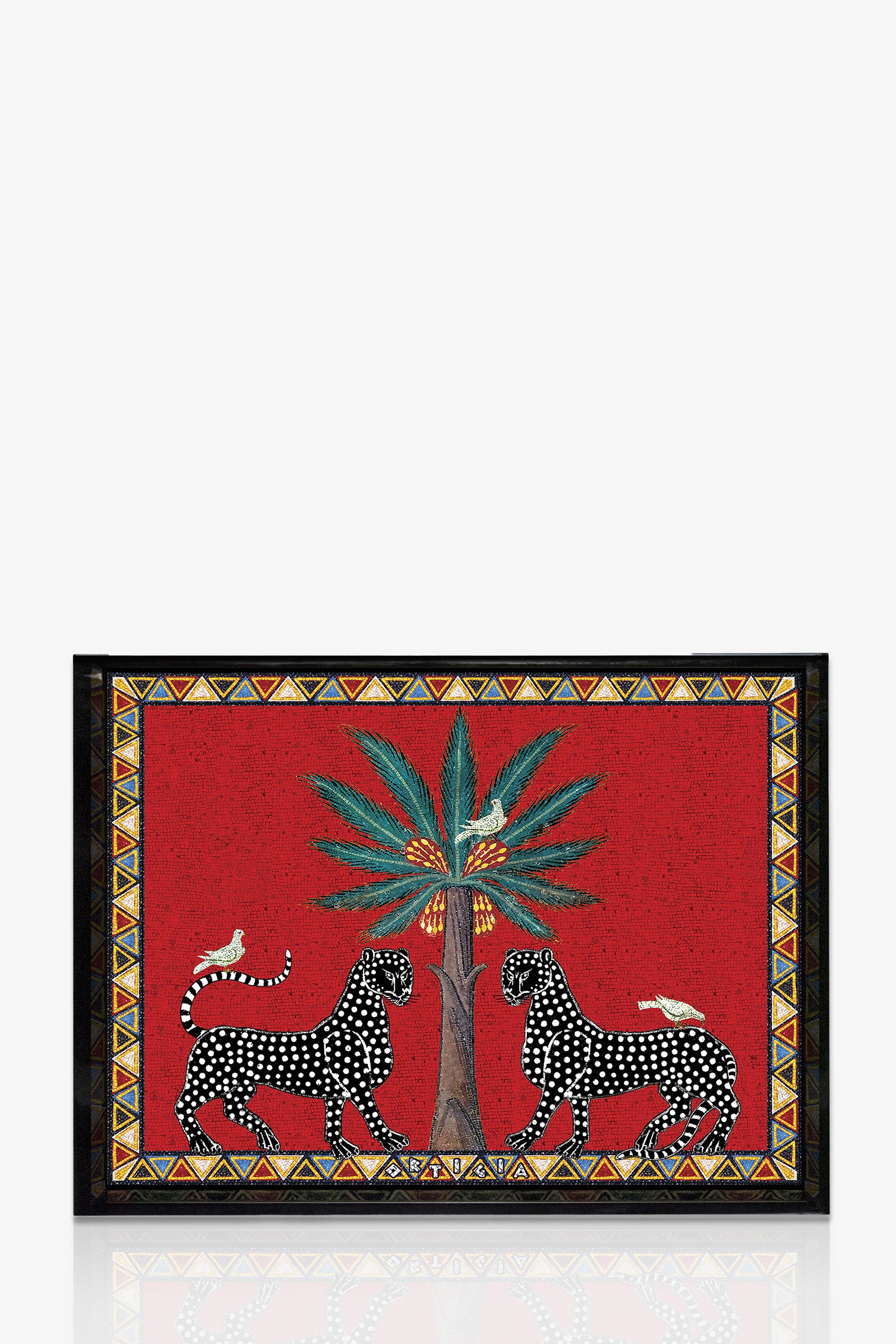 The Ortigia Medium Tray is a decorative rectangular tray with a red background, showcasing two black and white leopards facing each other beneath a palm tree with two perched birds, all framed by a geometric patterned border.
