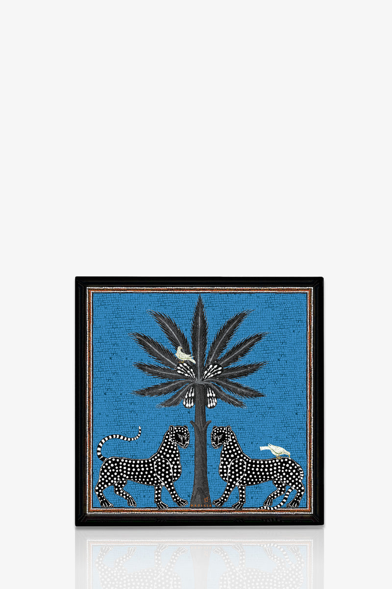 The Ortigia Square Tray features two black-and-white spotted leopards facing a tall, leafy plant on a bright blue background, with two white birds perched on the plant and one on a leopard’s back.