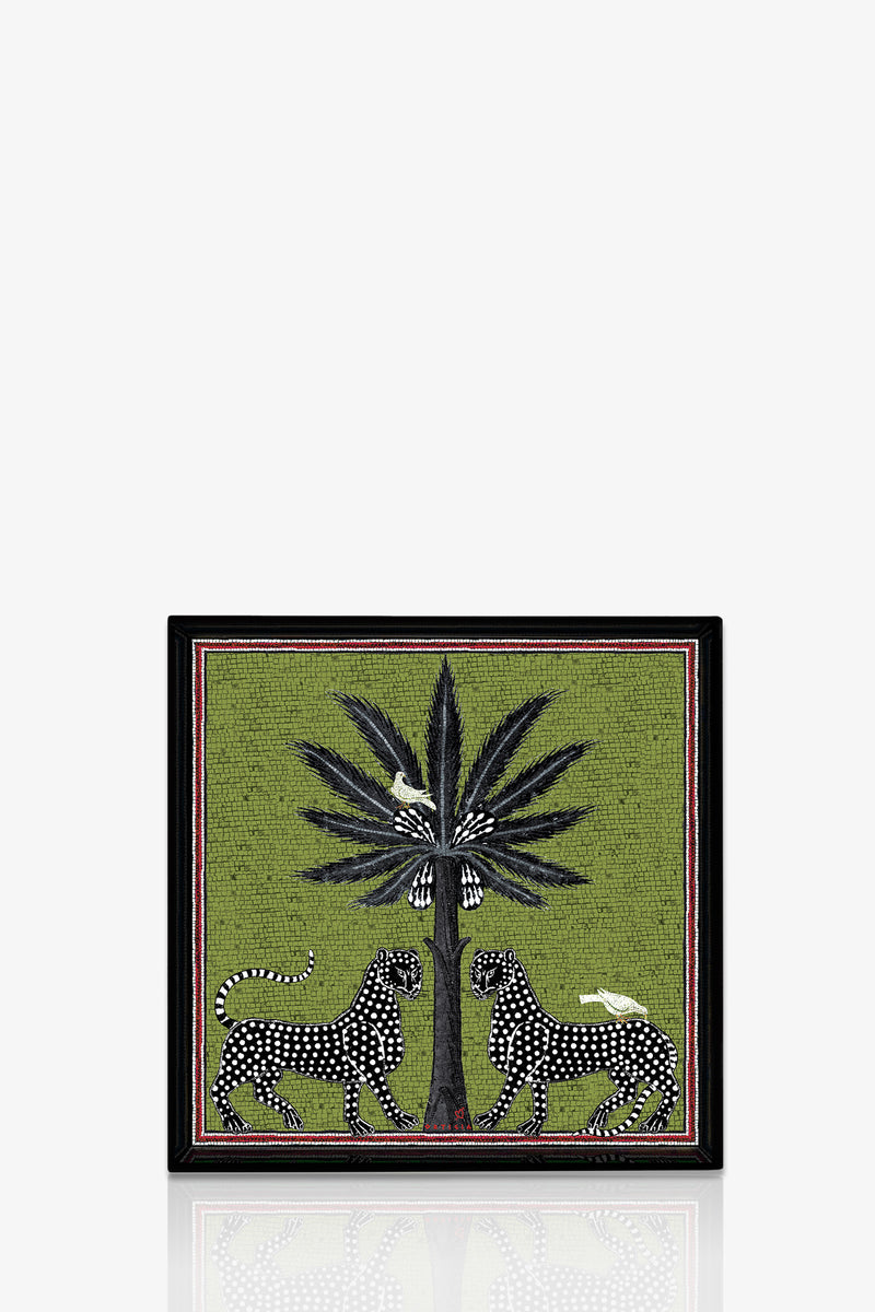The Ortigia Square Tray features a green background with two black and white spotted big cats facing each other under a tall dark palm tree, accented by white birds perched on the tree and on the cats’ backs.