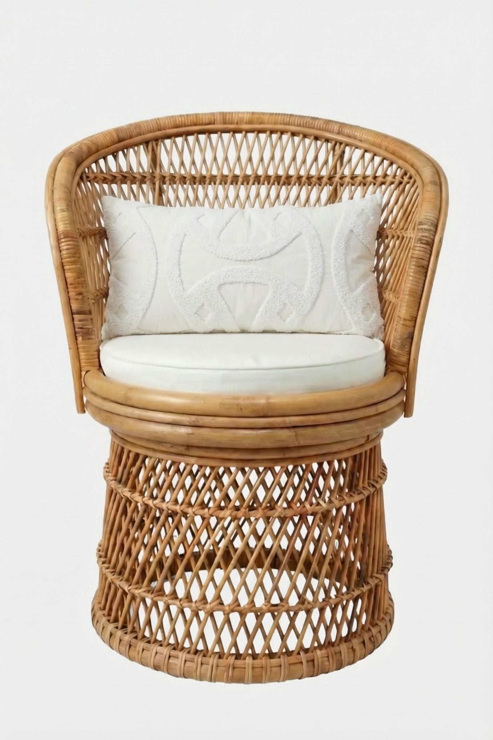A rattan swivel chair with an open-weave design, curved backrest, white seat cushion, and a Santorini White Tufted Throw Pillow 12"X24" as an accent, set against a plain white background.