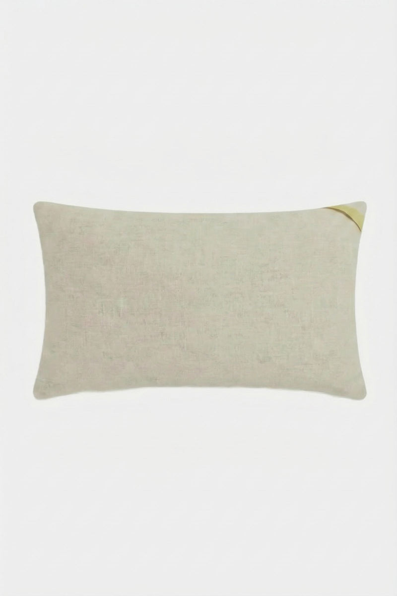 The Amazing Maze Embroidered Pillow is a rectangular, light beige pillow with a subtle texture and a small gold accent on the top right corner, shown against a plain white background.