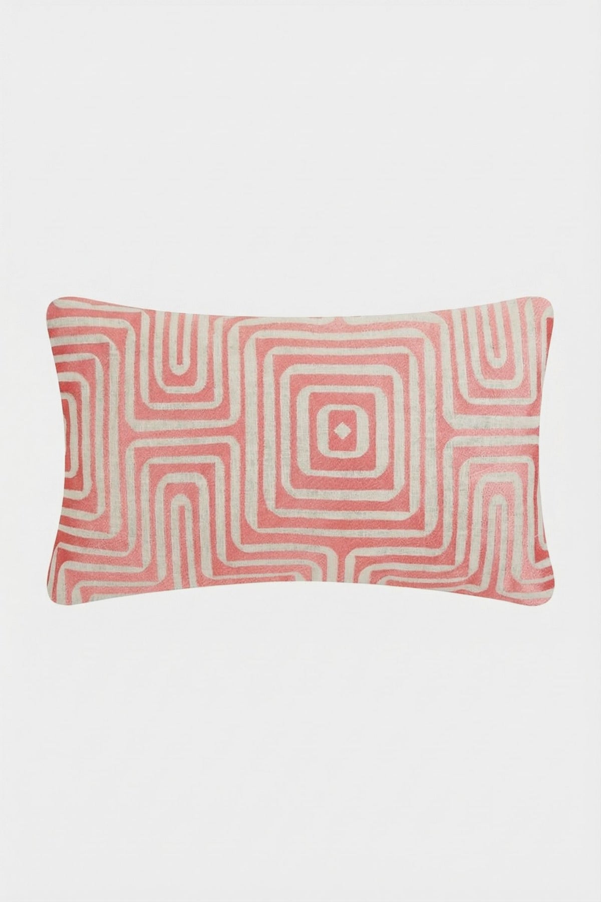 The Amazing Maze Embroidered Pillow features a geometric pattern of concentric squares in pink and off-white on a light background, with slightly rounded edges. Shown against a plain white backdrop.