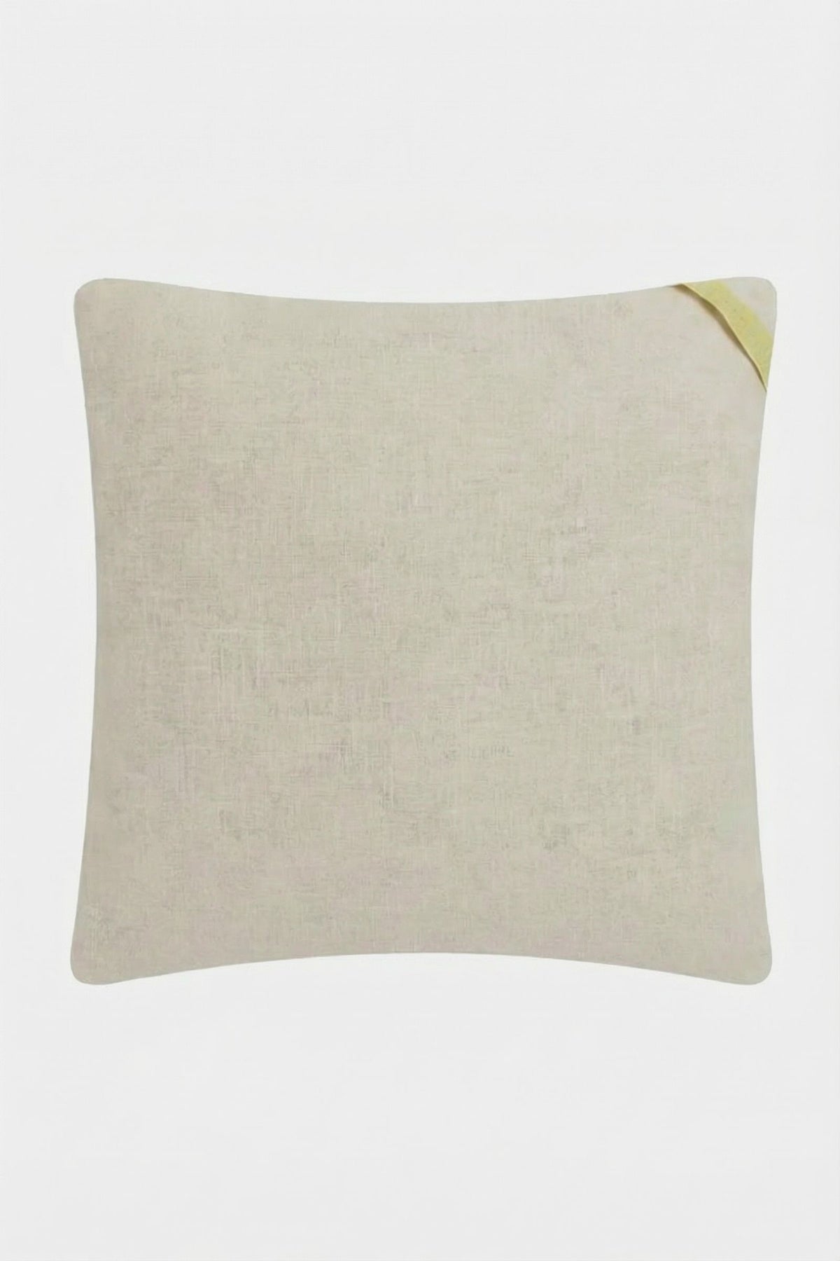 The CALEXICO EMB PILLOW 20X20" is a light beige pillow cover with subtle texture and a small yellow fabric loop at the top right corner, shown against a white background.