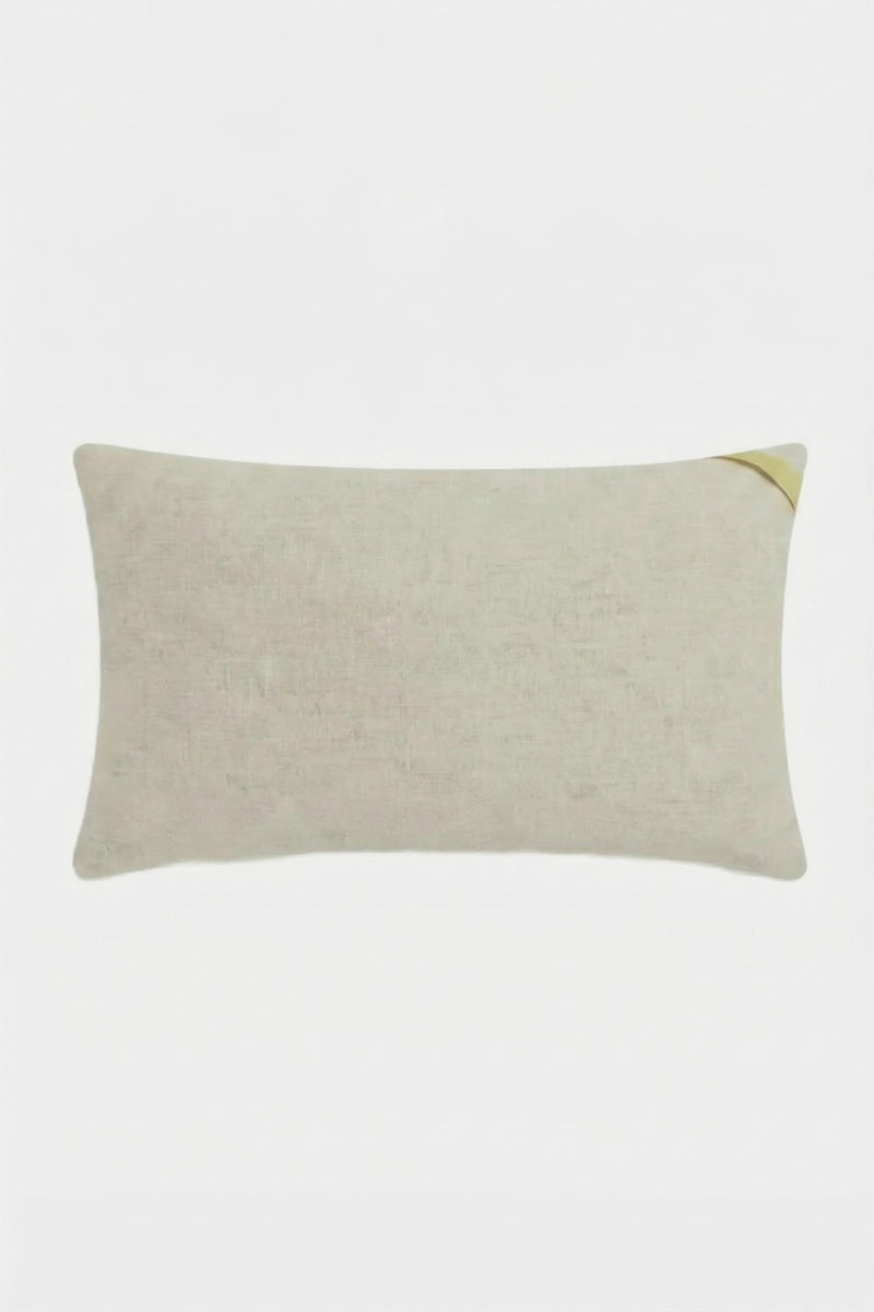 The Calistoga Embroidered Rainbow Lumbar Pillow is a rectangular beige accent pillow with a subtle woven texture and a small diagonal yellow detail on the top right, perfect as a stylish throw pillow for any space.