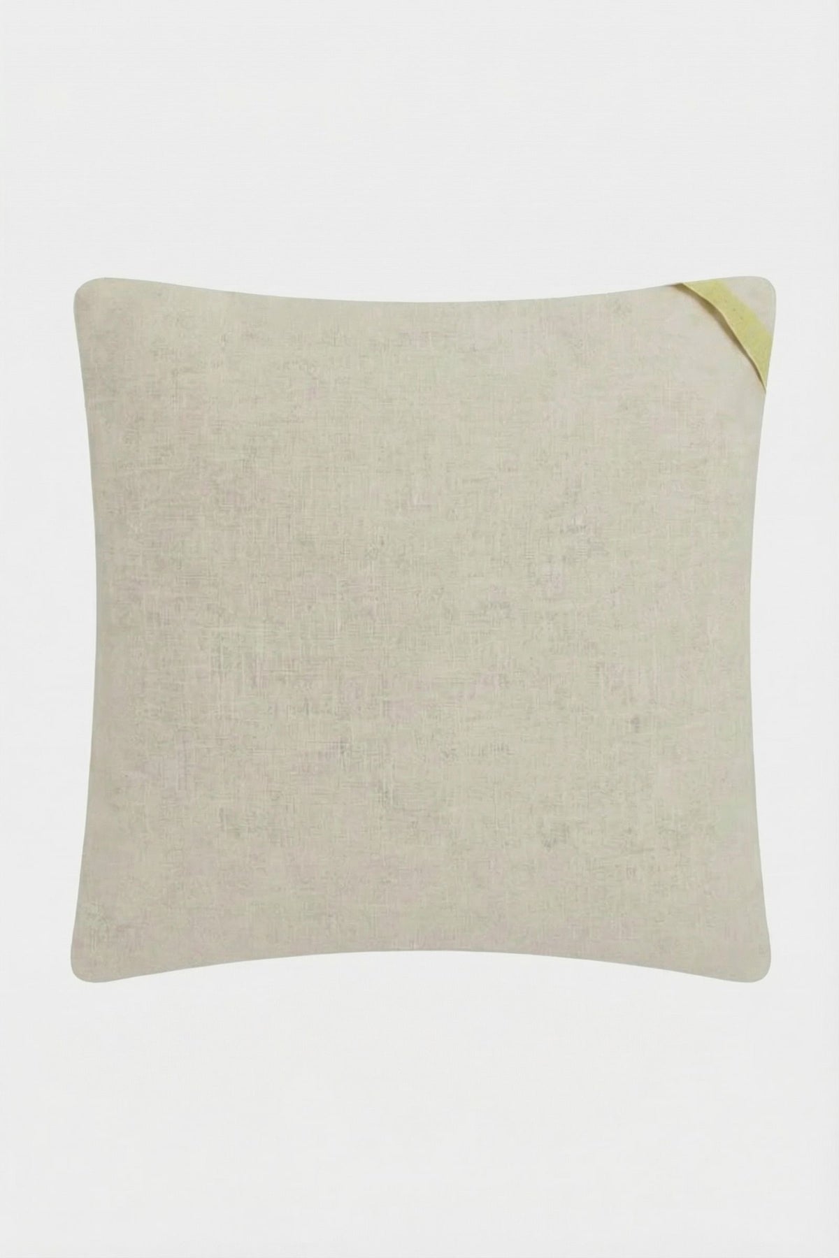 The Carmel Embroidered Pillow 20x20" is a square beige throw pillow with subtle texture and a small yellow fabric loop on one corner, shown against a plain white background.
