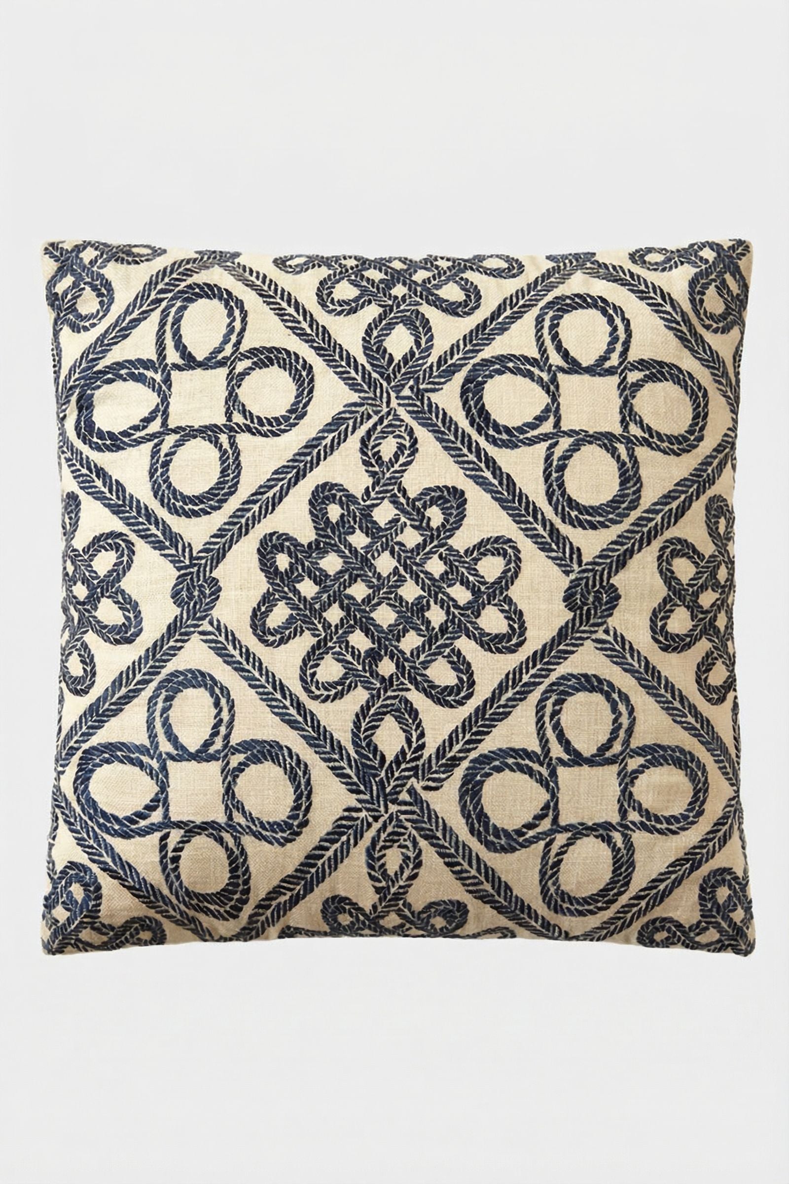 The Costa Mesa Embroidered Throw Pillow features intricate navy blue geometric and knot patterns on a beige background, with repeating loops, diamonds, and interwoven shapes for a stylish decorative accent.