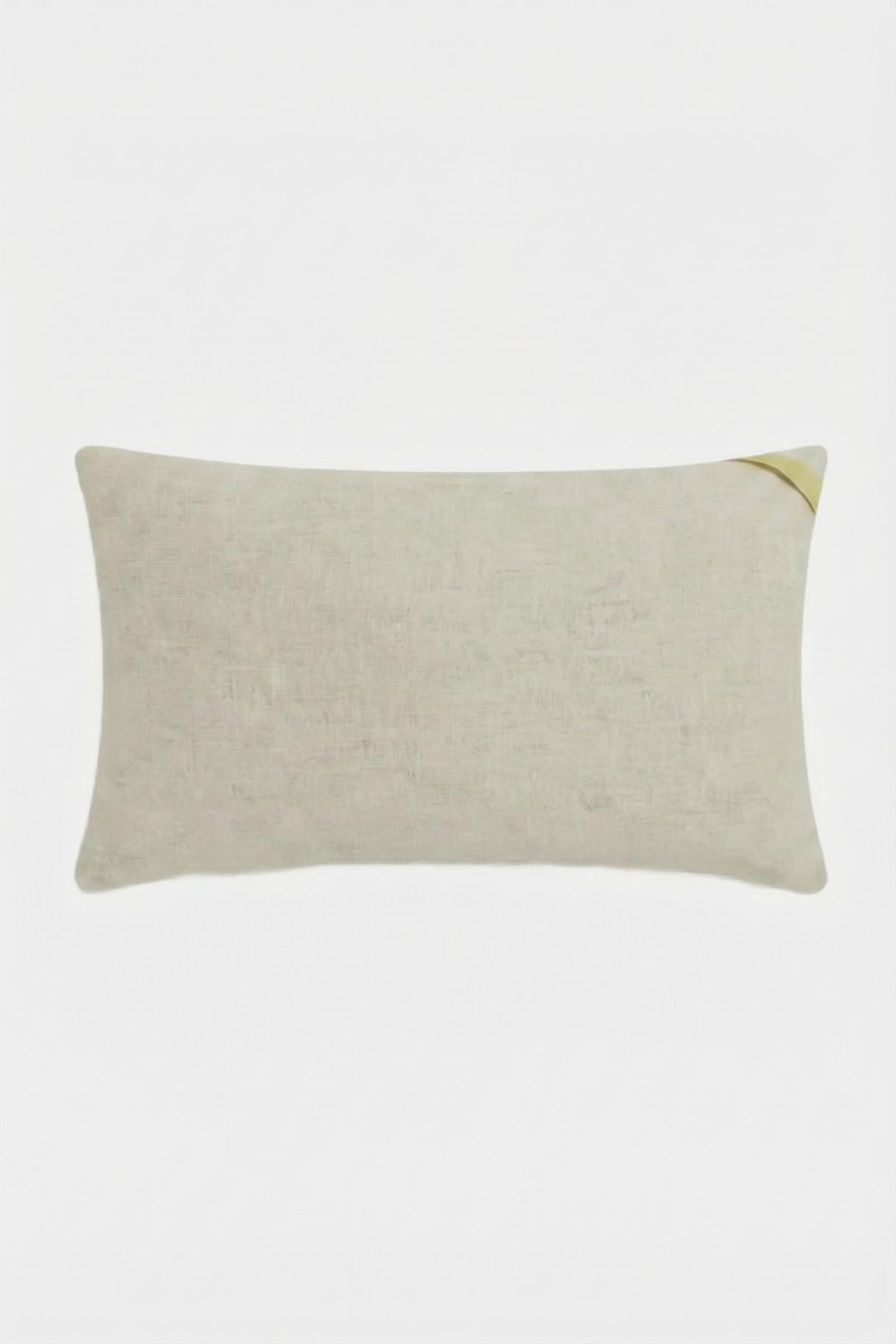 The Escondido Embroidered Lumbar Pillow is a rectangular light beige pillow with a small yellow corner accent, shown on a plain white background.