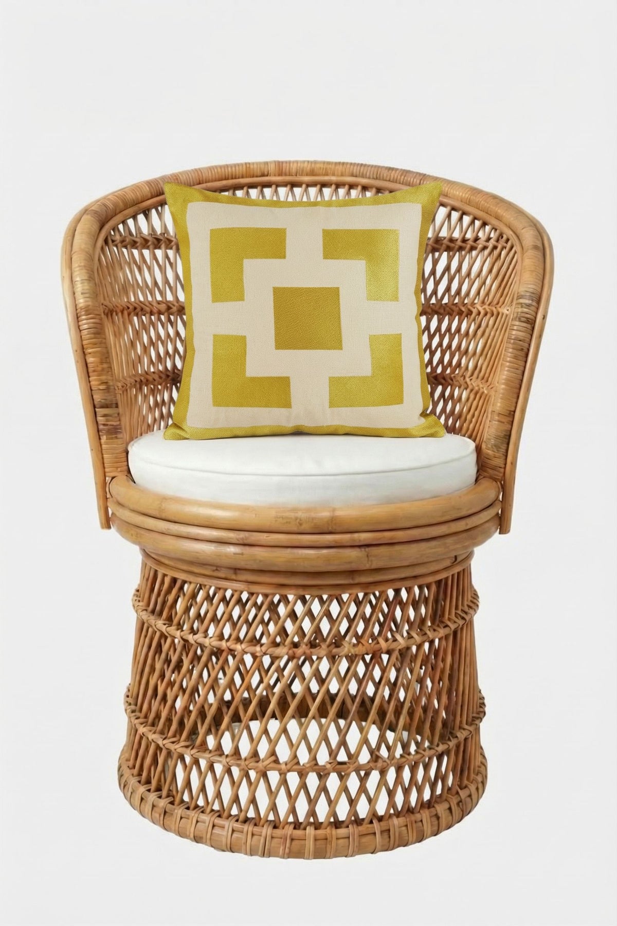 A round wicker chair with a white seat cushion and a 20"x20" Palm Springs Block Embroidered Pillow, filled with down feathers, displayed against a plain white background.