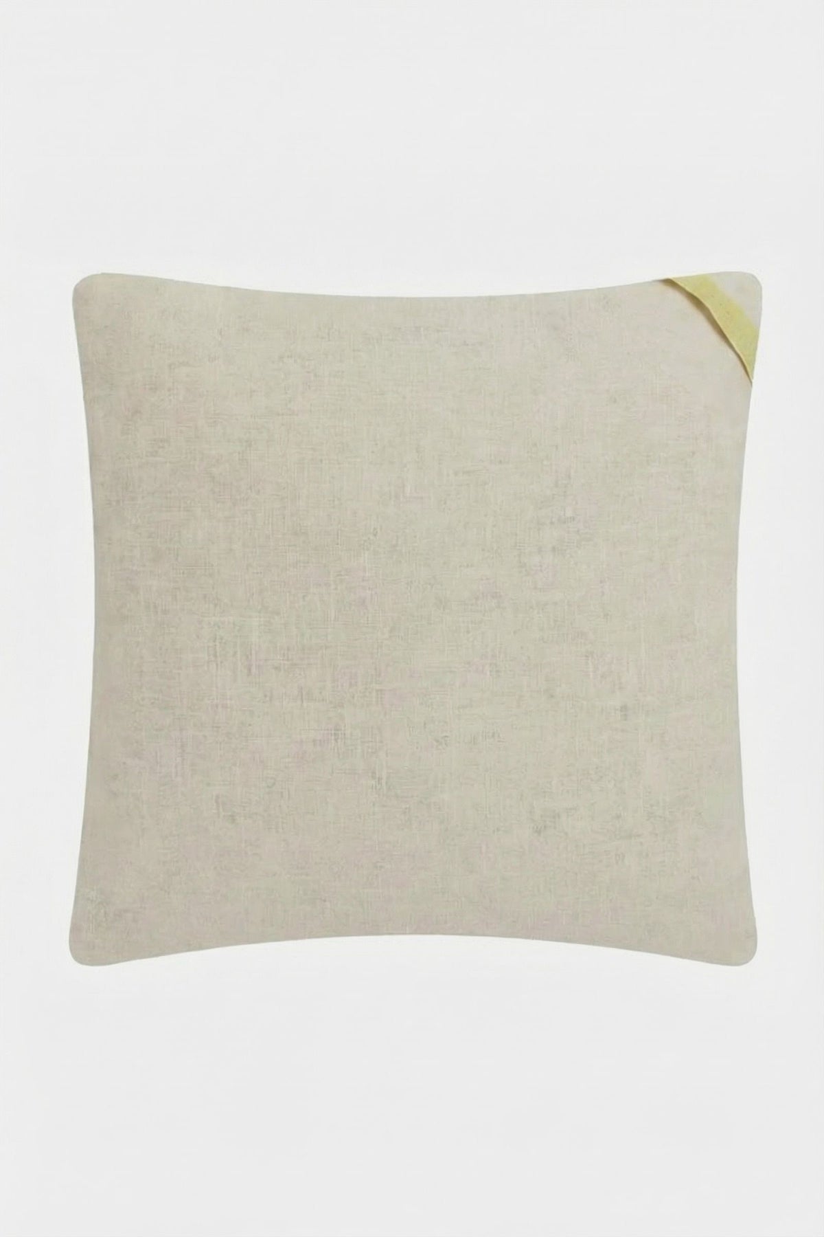 The Palm Springs Block Embroidered Pillow is a square 20"x20" light beige cushion with subtle texture, accented by a small yellow fabric loop on the top right corner, shown against a plain white background.