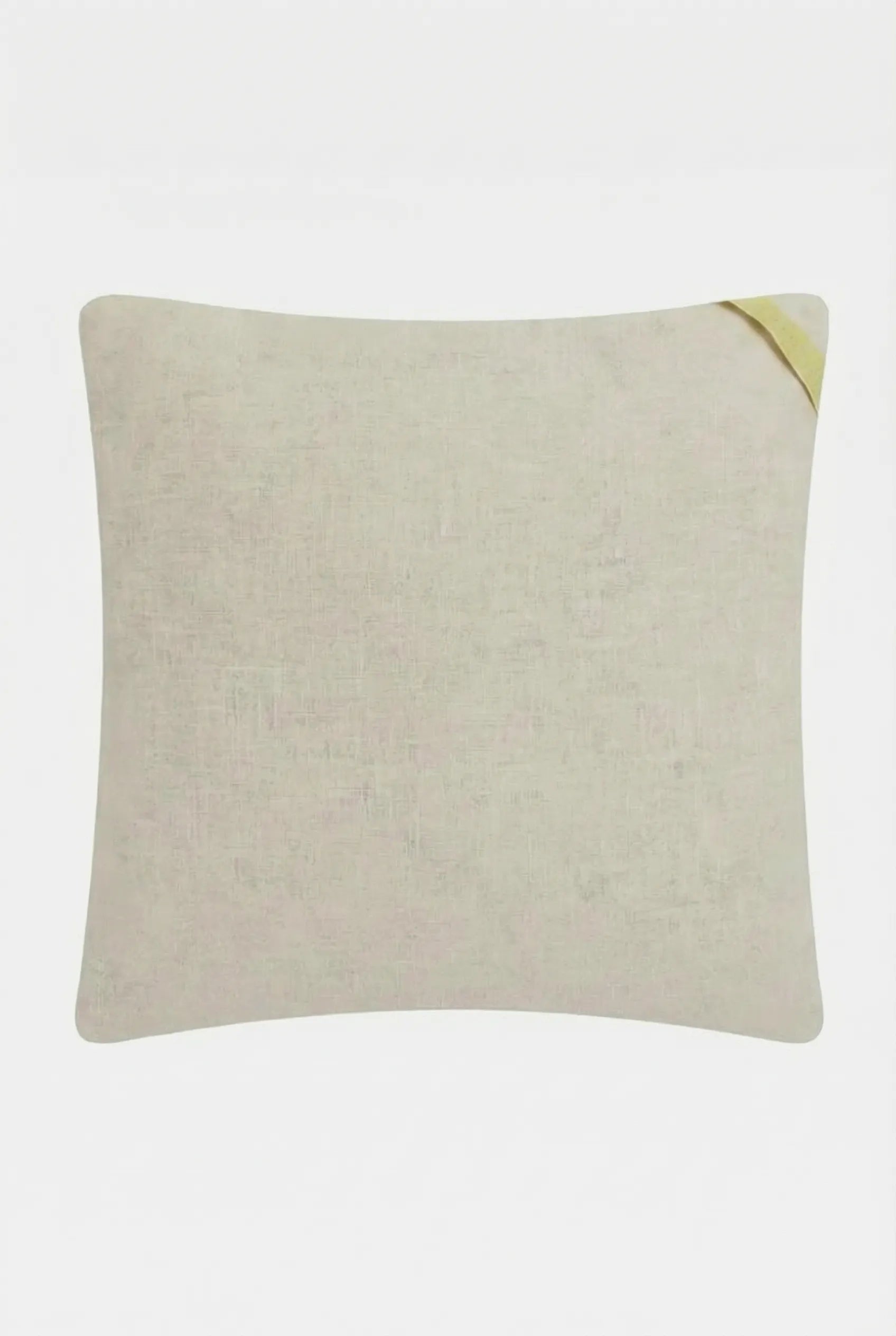 The Pasadena Embroidered Throw Pillow is a square, beige cushion with subtle texture and a small yellow fabric loop on the upper right corner, shown against a plain white background.