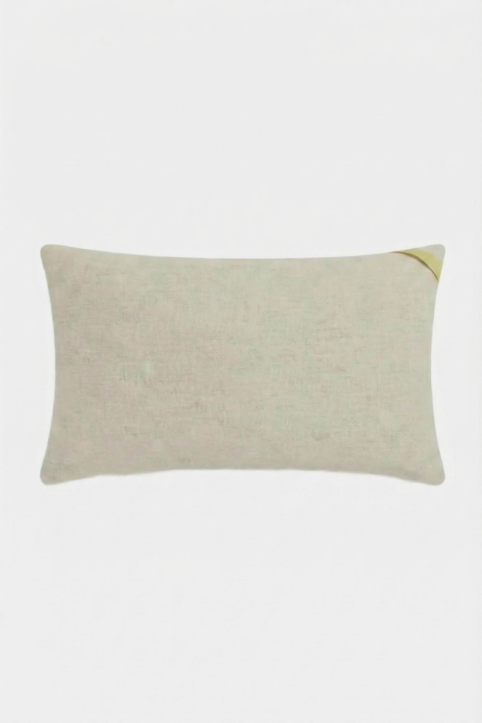 The Roseville Embroidered Lumbar Pillow is a rectangular beige pillow with a subtle texture, shown with a small corner fold at the top right on a plain white background.