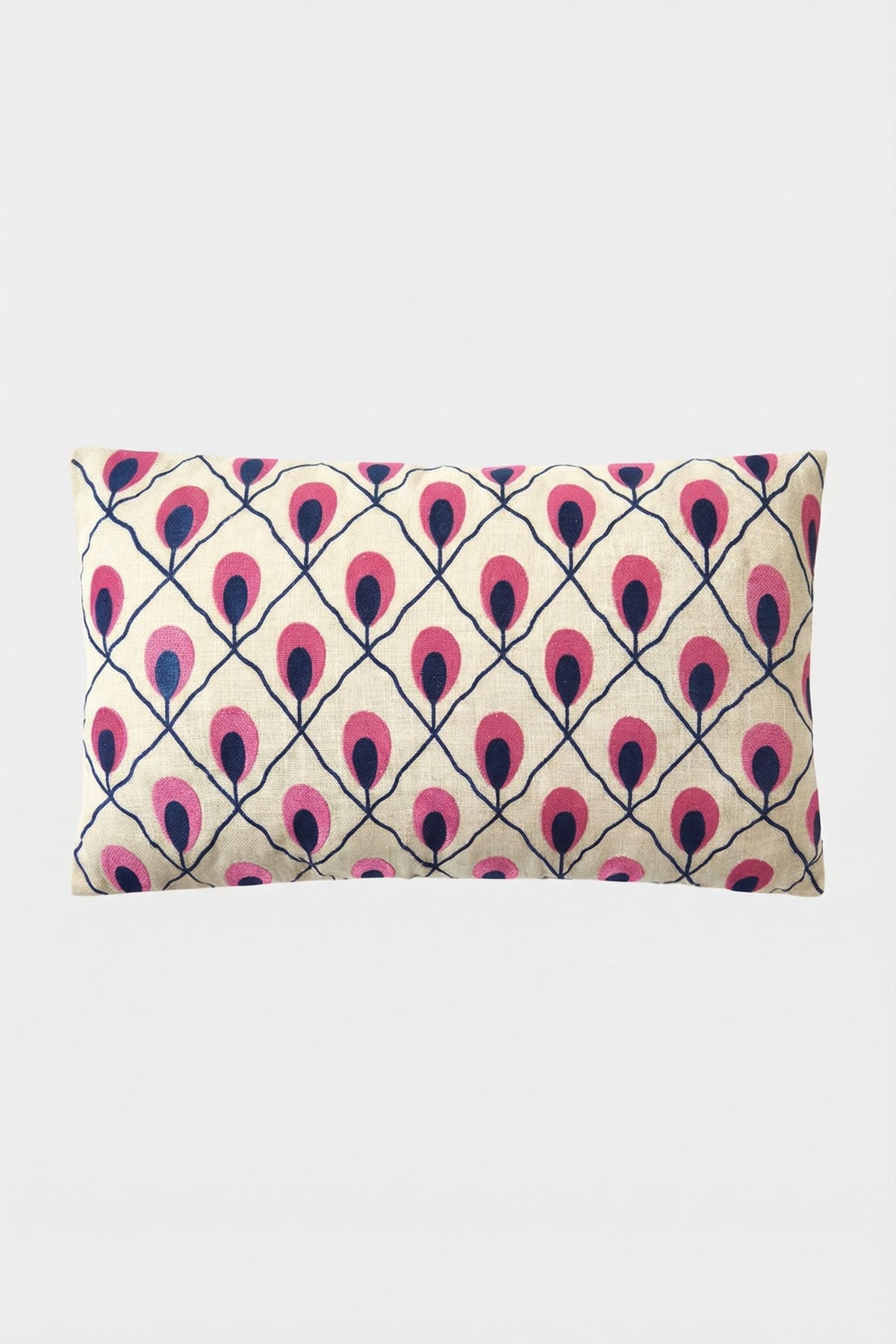 The Roseville Embroidered Lumbar Pillow features a cream background with a geometric pattern of stylized pink and dark blue peacock feathers.