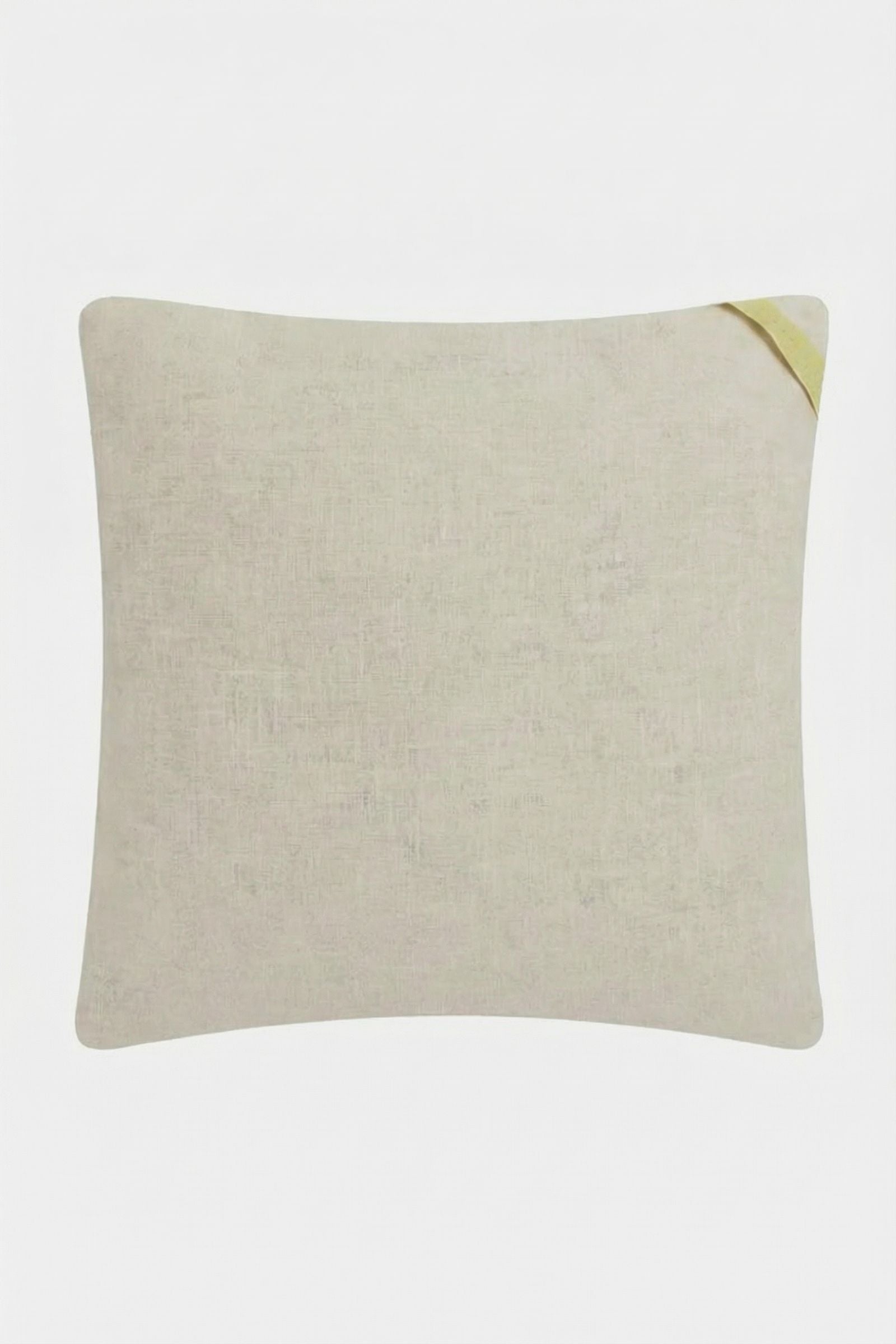 The Shante Embroidered Pillow is a plain, light beige rectangular pillow with a small yellow fabric loop on one corner, shown against a white background.