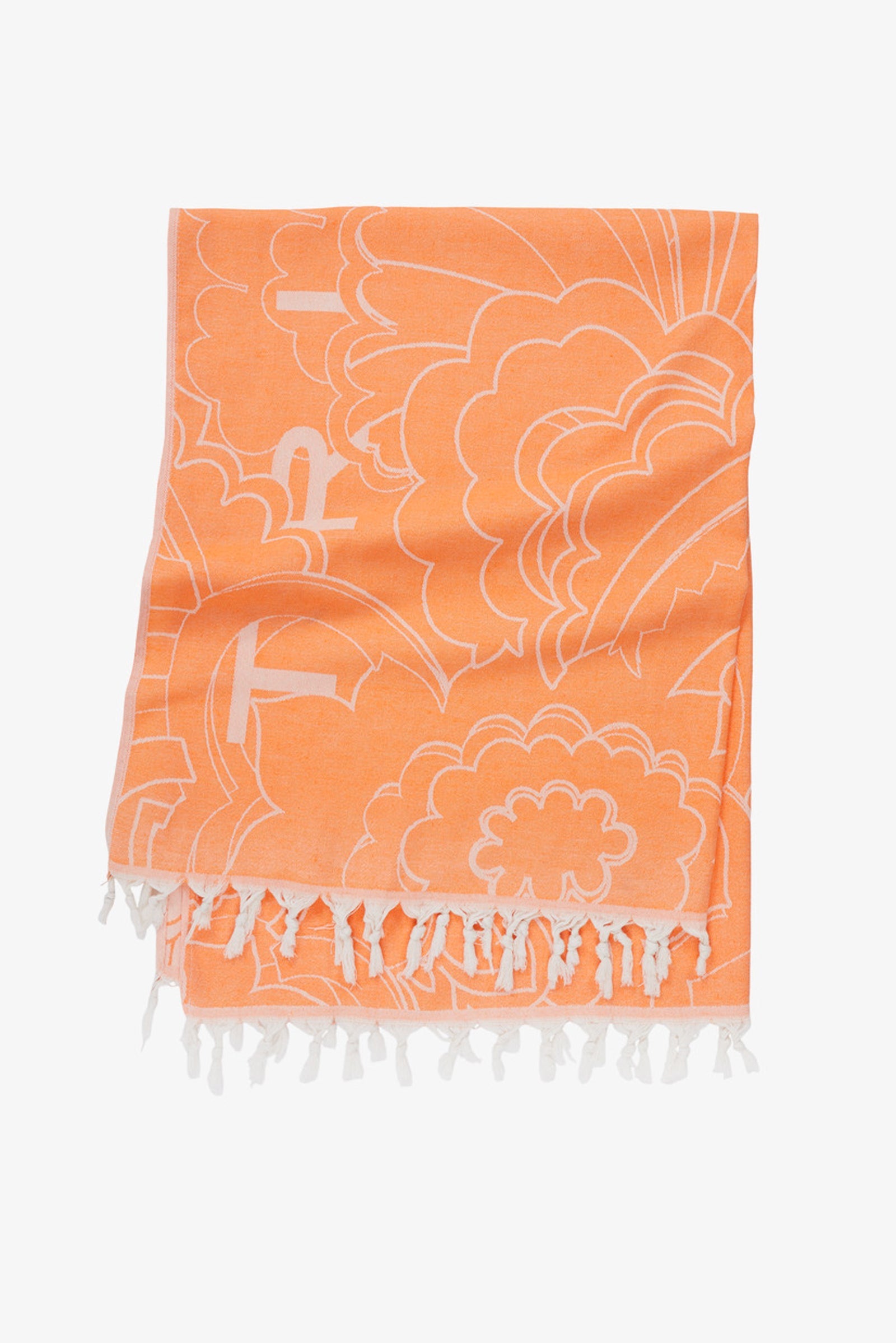 The Floral Cloud Turkish Towel features a folded orange design with a white floral pattern and fringed tassels, displayed on a plain white background. Lightweight and absorbent, it combines everyday style and function.