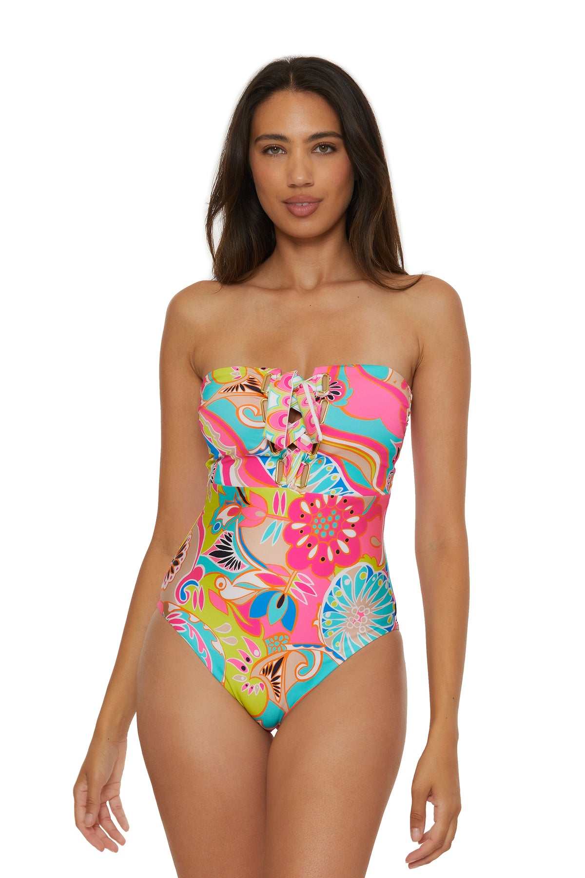 A woman models the Venus Lace-Up Bandeau One-Piece Swimsuit, a colorful, strapless design with floral and abstract patterns and a lace-up chest detail, set against a white background.