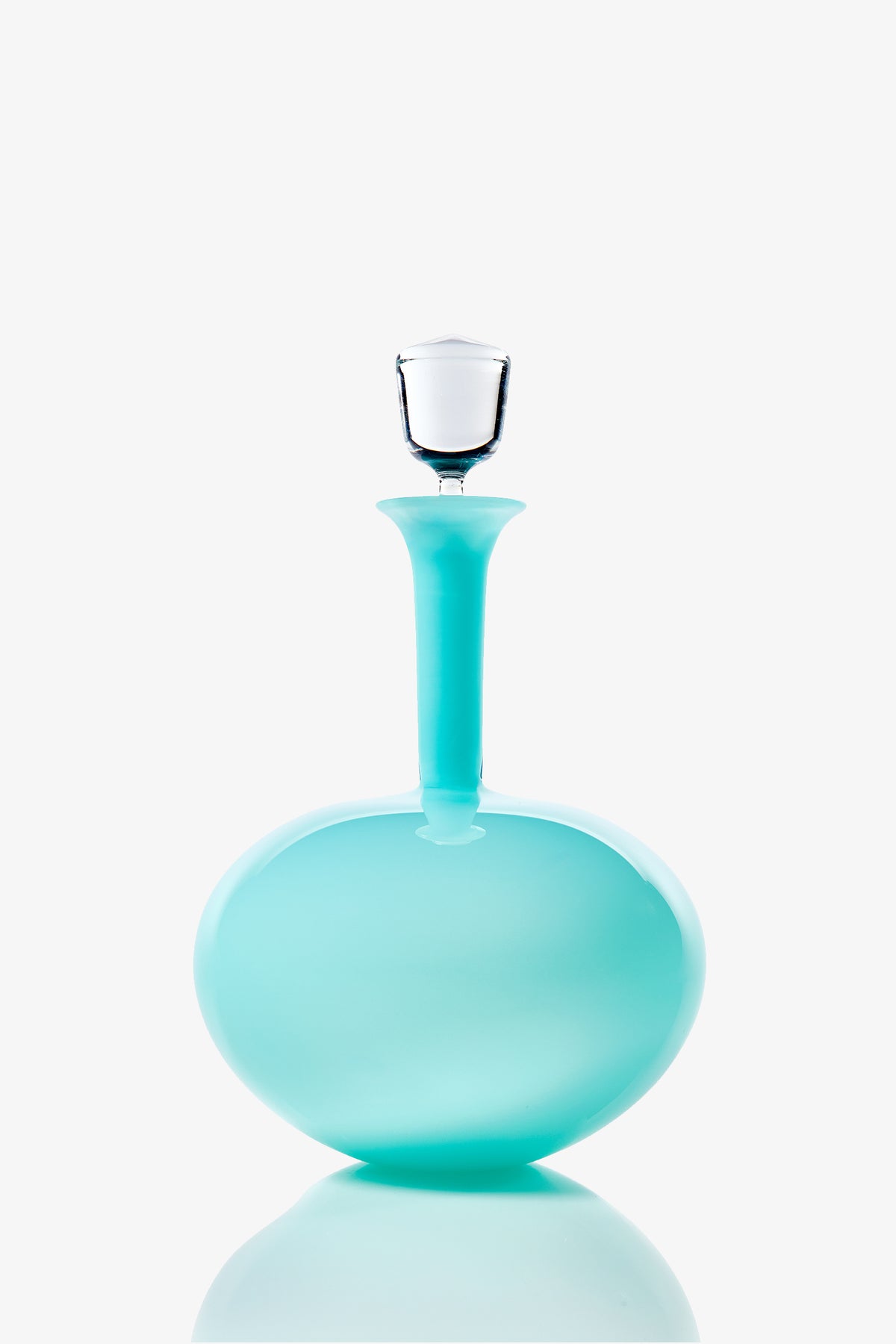 The Wexler Low Oval Bottle, a turquoise glass decanter with a wide base and narrow neck topped with a clear glass stopper, is displayed against a white background.