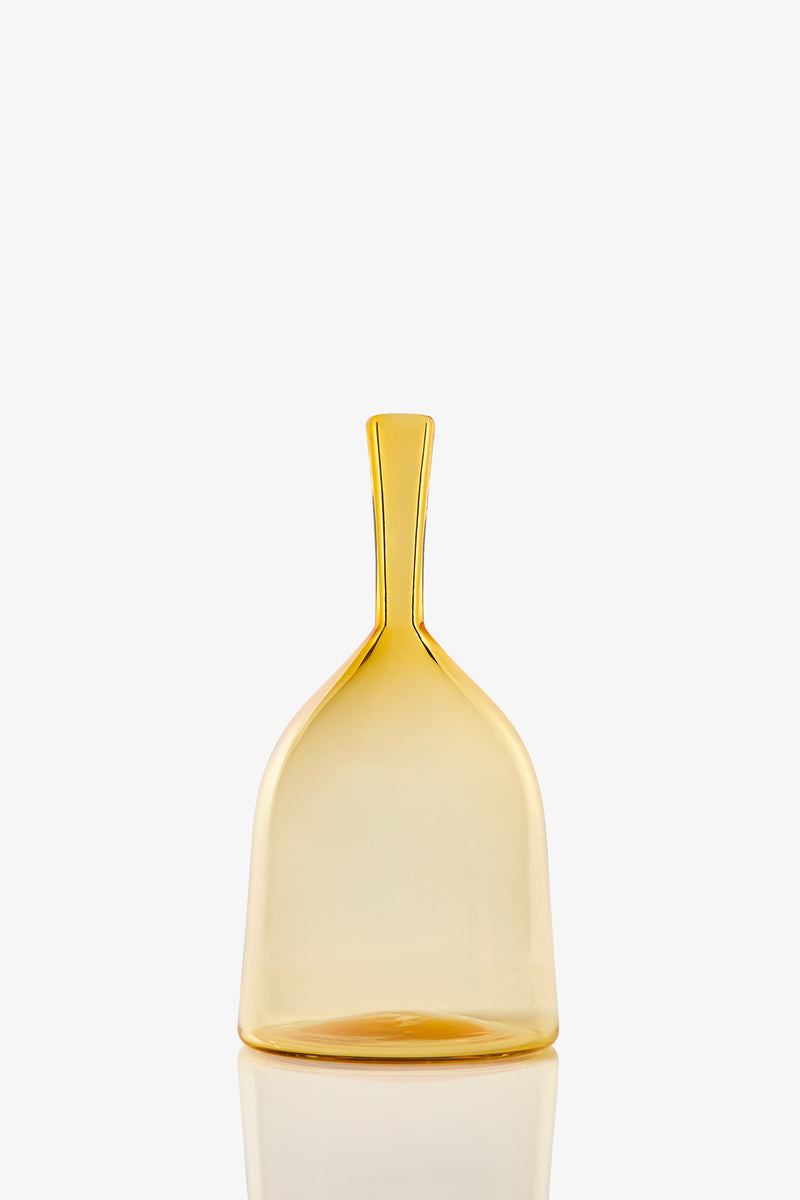 The Wide Angelic Bottle is a translucent yellow glass bottle with a wide base and a tall, narrow neck, shown against a plain white background.