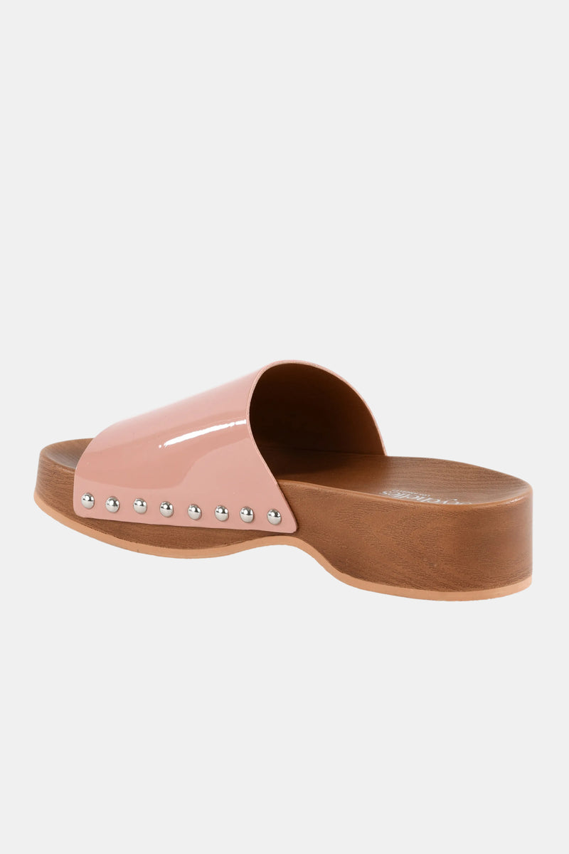 The Seychelles Fantasy Patnt Slide features a light brown platform sole, a shiny pink strap adorned with silver studs, and is displayed against a plain white background.