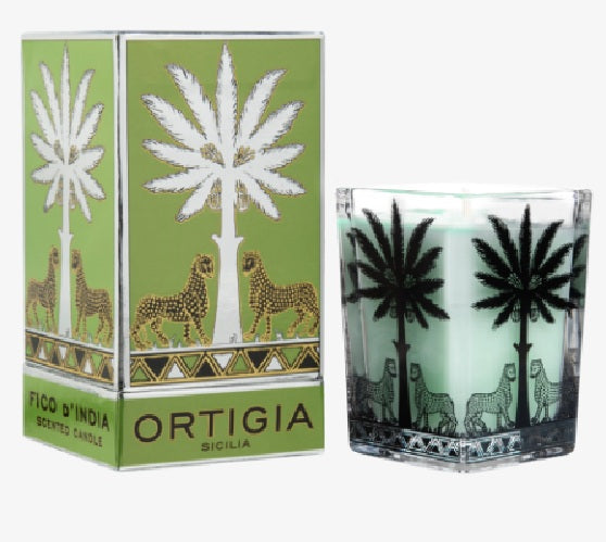 A GREEN Ortigia Candle Large Square, featuring palm tree and leopard designs, sits next to its matching green box with similar artwork and the Fico d’India Scented Candle label.