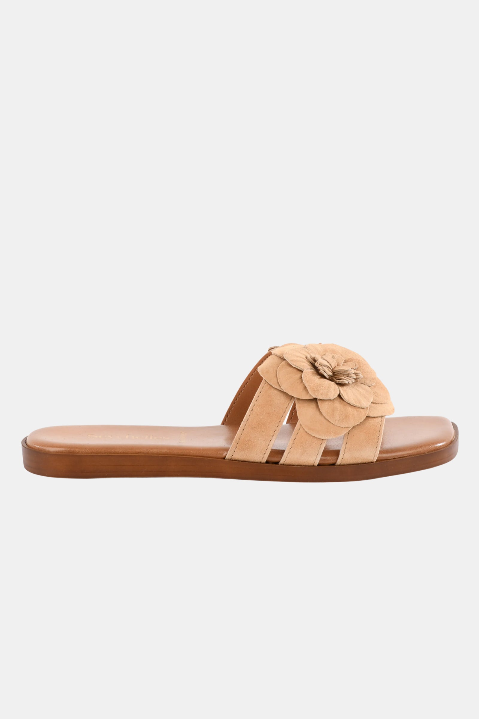 The Seychelles Morning Dew Slide in NATURAL features a tan flat design with a brown sole and a large suede flower on the top strap, shown against a plain white background.