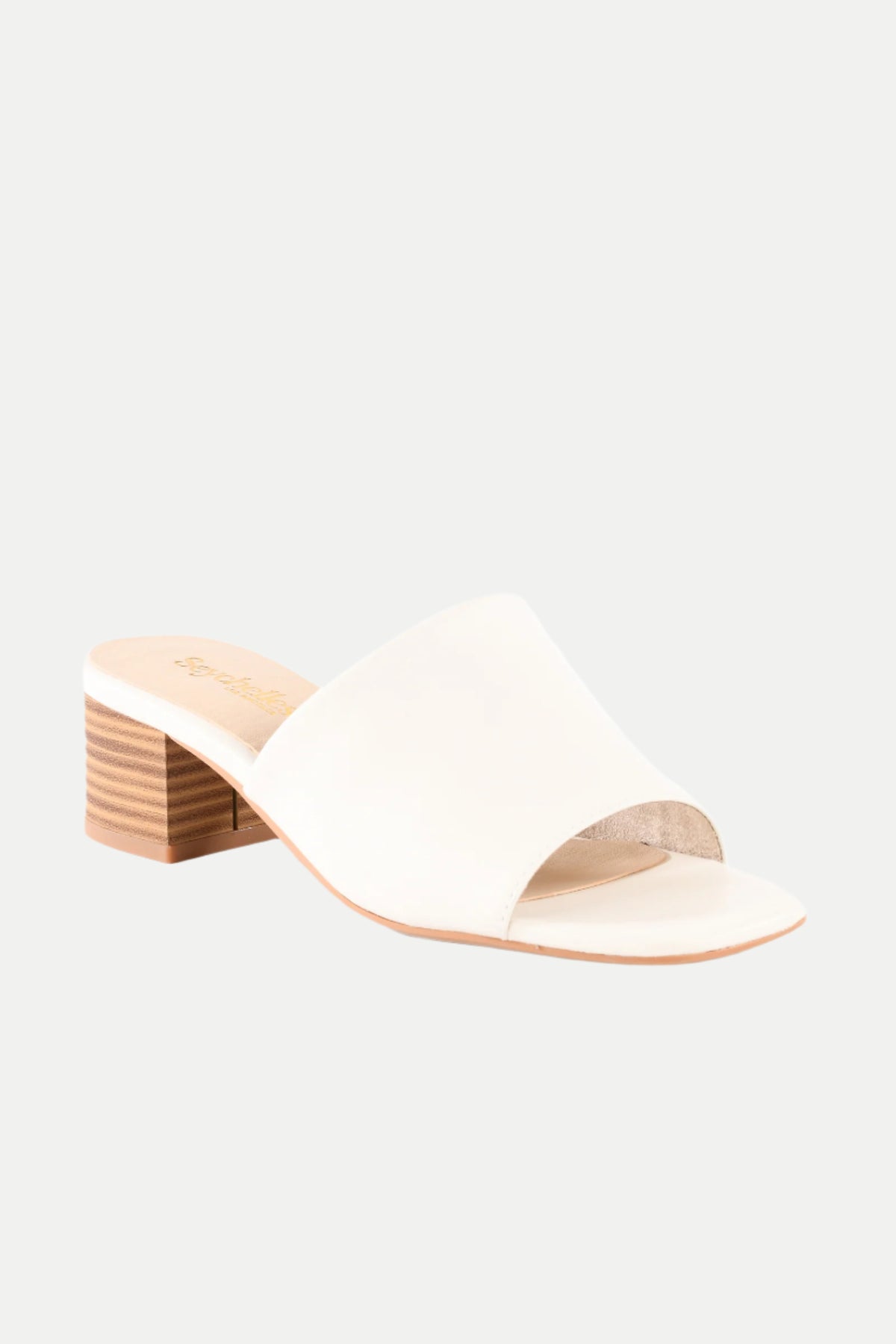 The Pepper White Leather Heeled Mule Sandal features a wide strap, open toe, low stacked wooden block heel, and flat sole, shown against a plain light background.