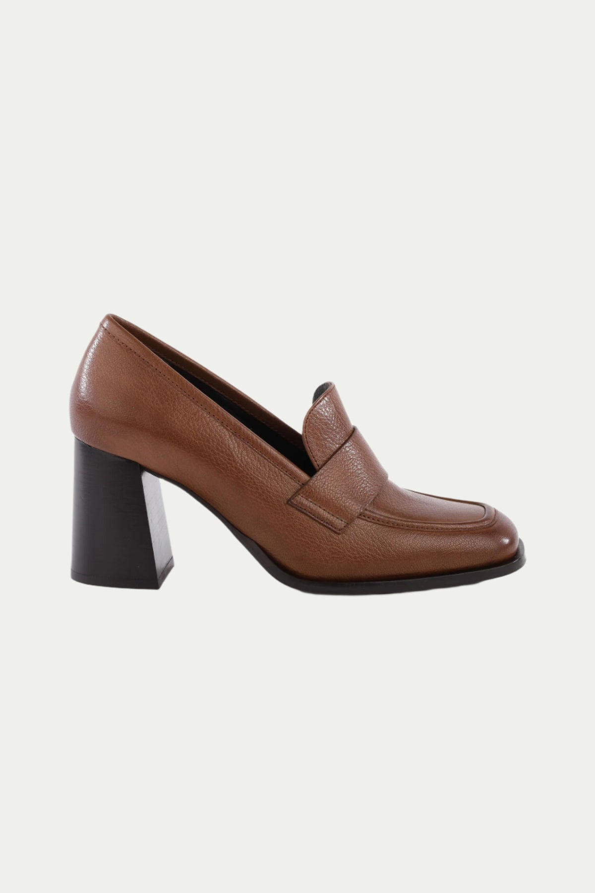 The Run The World Brown Leather Heeled Loafer in dark brown features a rounded toe, chunky black block heel, and cushioned insole for all-day comfort, shown on a plain white background.