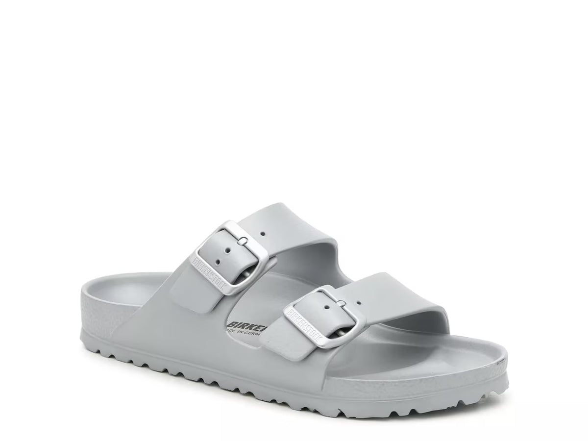 The Birkenstock Arizona Eva Sandal is a light gray slide sandal featuring two adjustable buckle straps and a textured sole, shown on a white background.