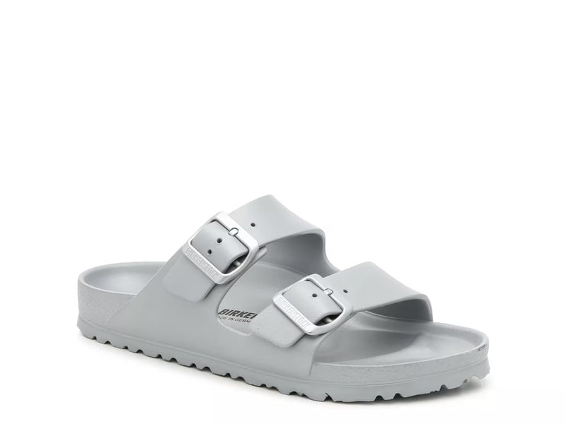 The Birkenstock Arizona Eva Sandal is a light gray slide sandal featuring two adjustable buckle straps and a textured sole, shown on a white background.